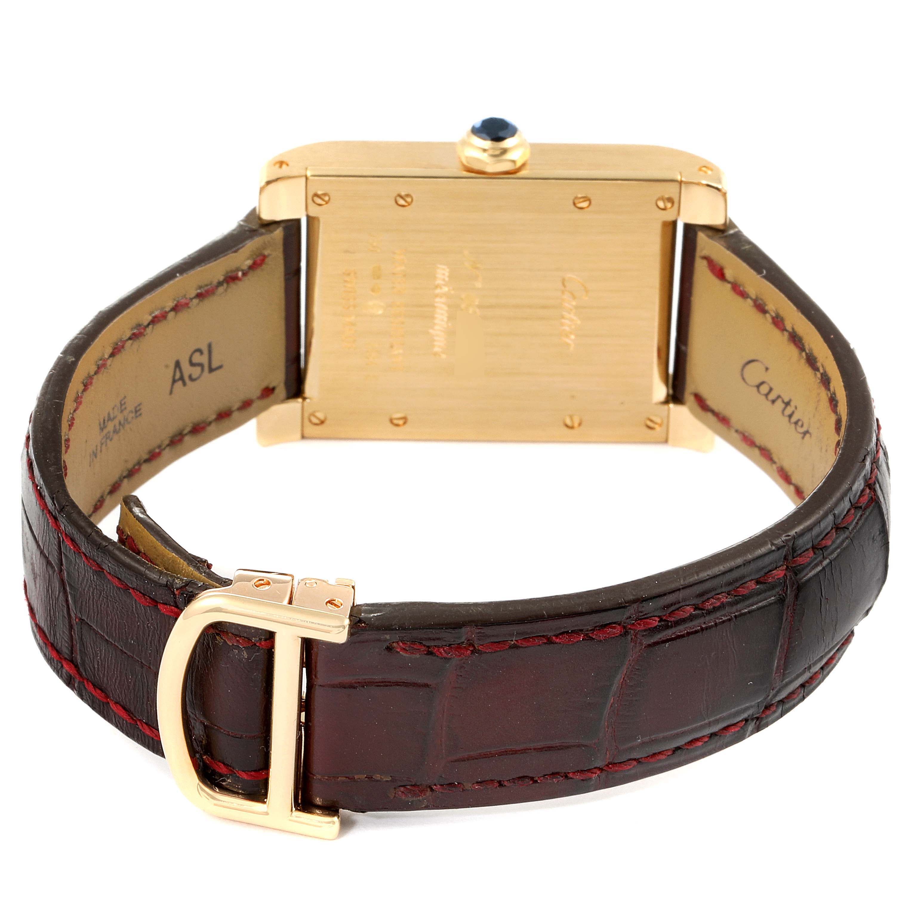 The image shows the back and strap of the Tank A Vis model by Cartier, highlighting the case back and buckle.