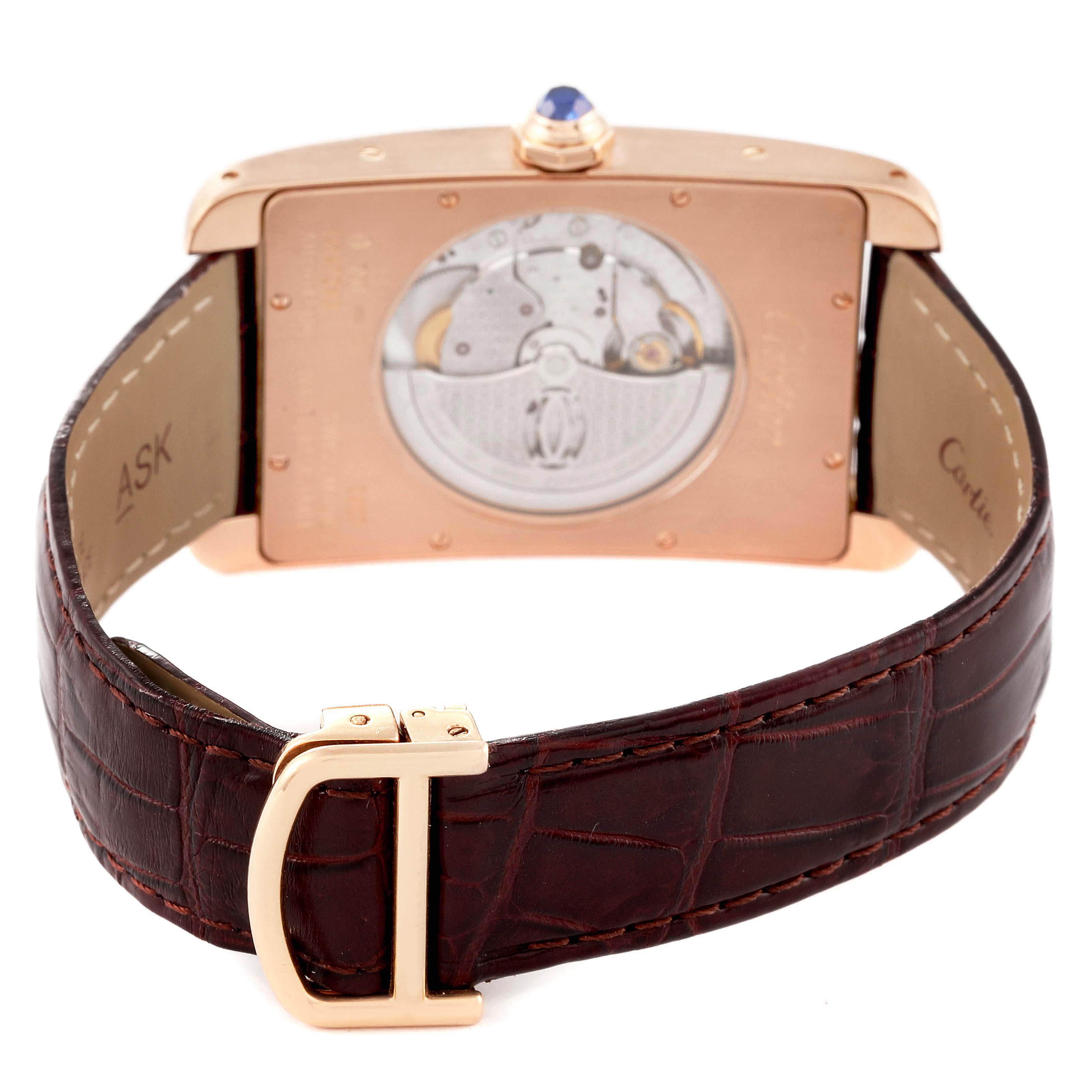 The image shows the back view of a Cartier Tank Americaine W2609856 Men
s Rose Gold Silver Dial W2609856 Men
s Rose Gold Silver Dial watch, highlighting its movement and brown leather strap.