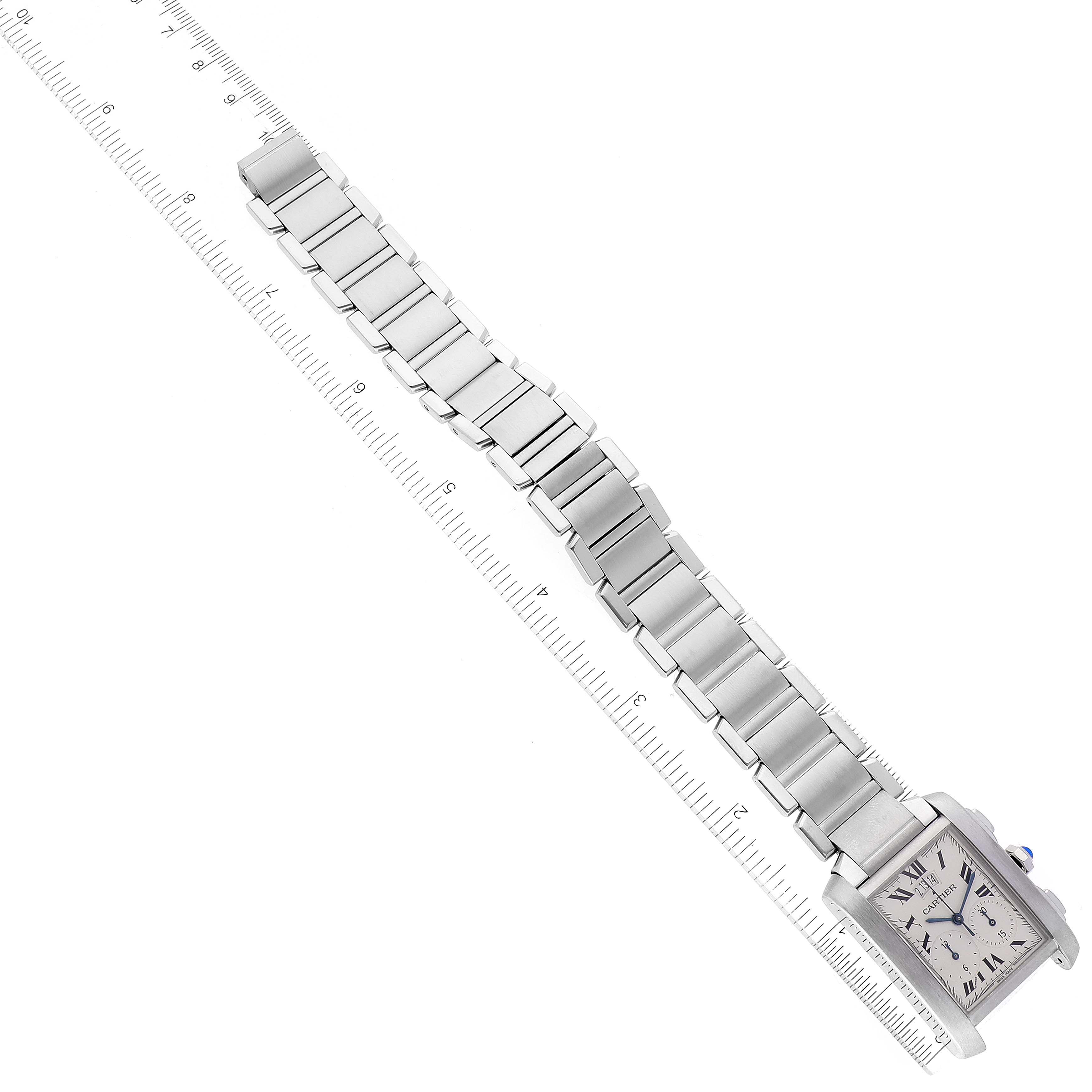 The image shows a Cartier Tank Française watch, laying flat with its metal bracelet fully extended and aligned alongside a ruler for measurement.