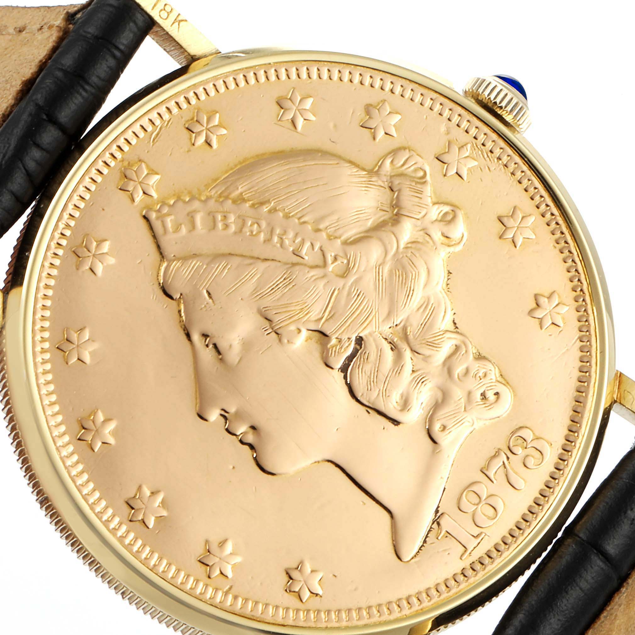 The image shows a close-up of the face and bezel of the Baume & Mercier  Men's Yellow Gold Black Dial  Men's Yellow Gold Black Dial 20 Dollars Double Eagle Yellow Gold Coin Automatic Mens Watch 1873 model.