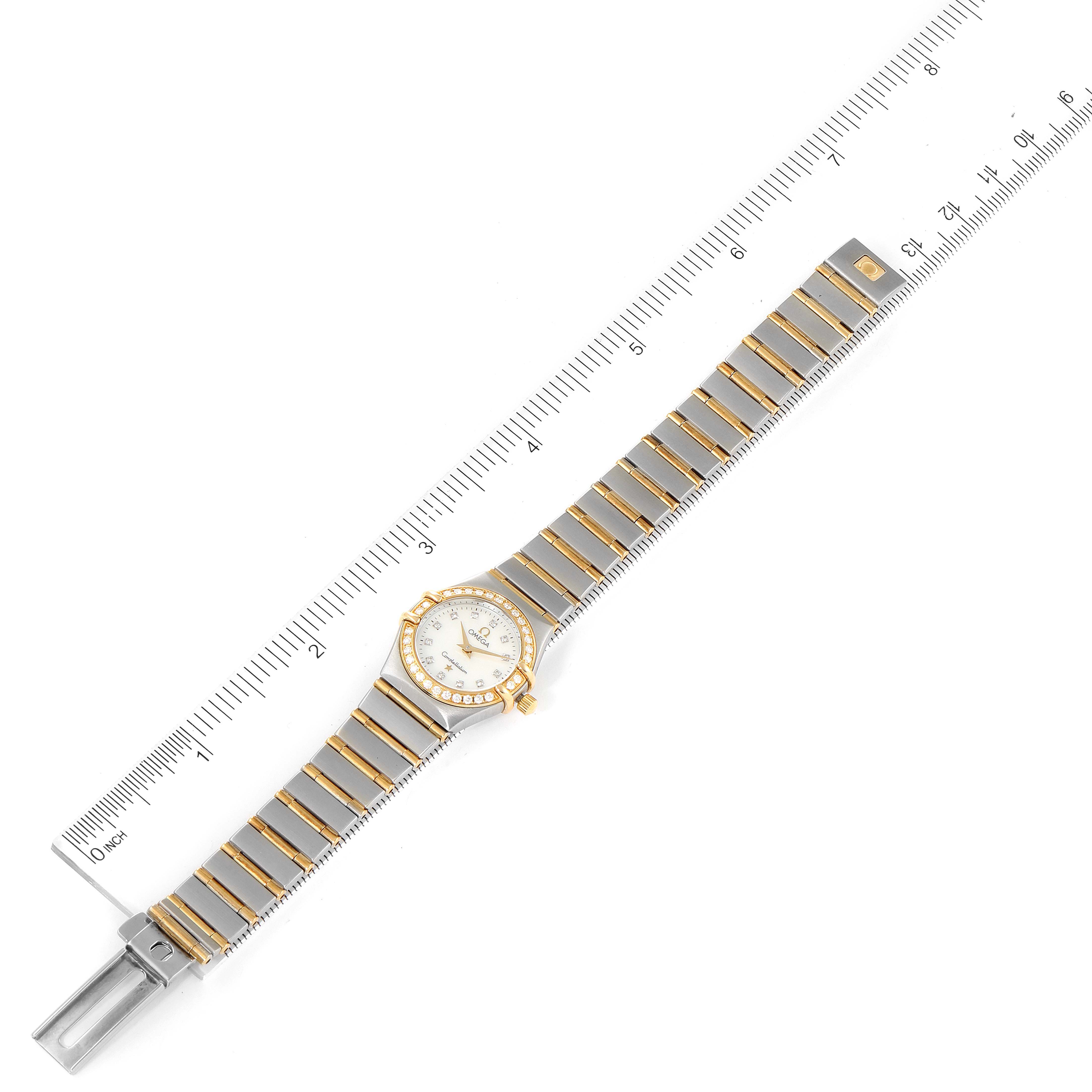 The image shows an overhead view of the Omega 1267.75.00 Women
s Steel and Gold (two tone) Mother of Pearl Dial 1267.75.00 Women
s Steel and Gold (two tone) Mother of Pearl Dial Constellation 95 Mother of Pearl Diamond Ladies Watch 1267.75.00 model next to a ruler.