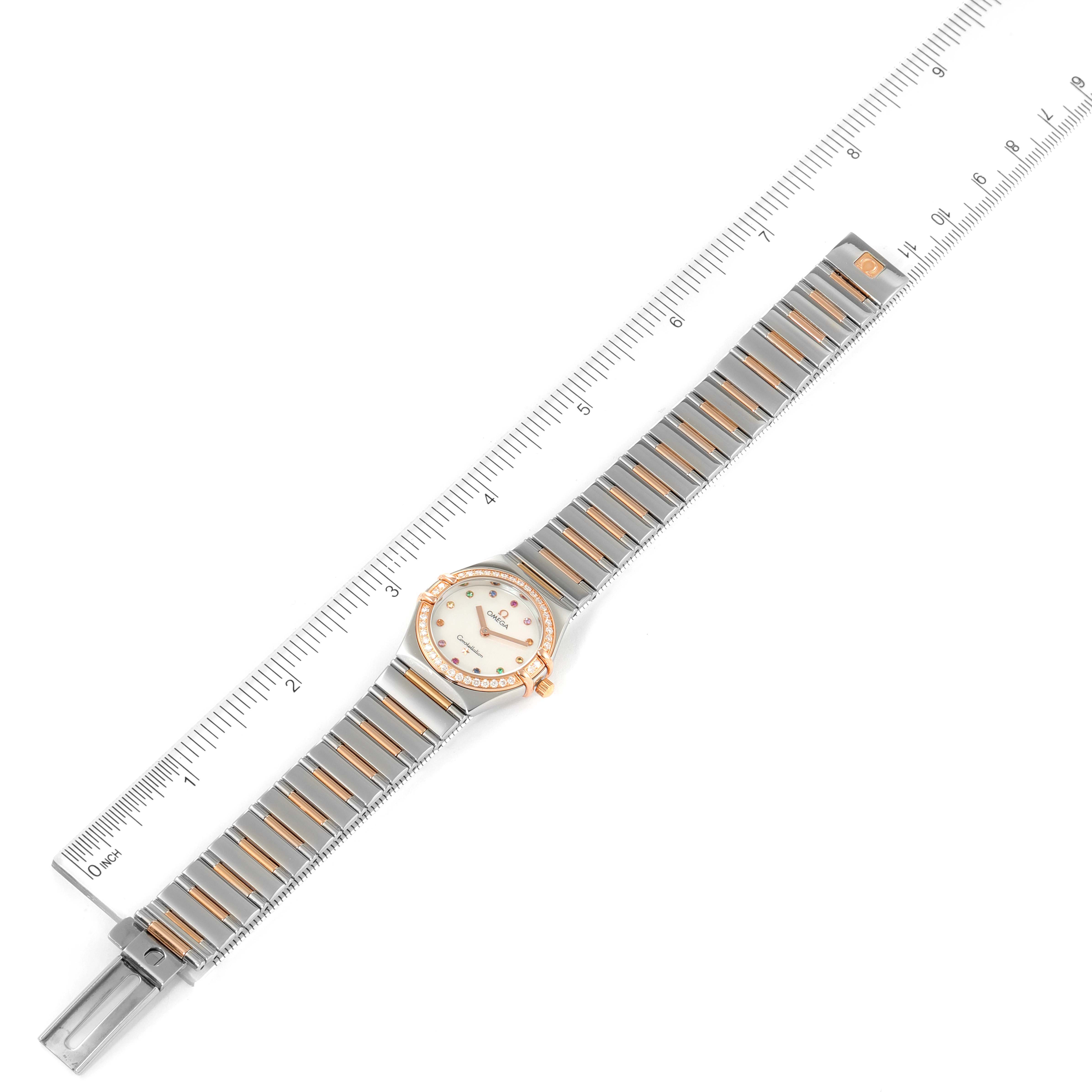 The Omega 1373.79.00 Women's Steel and Gold (two tone) Mother of Pearl Dial 1373.79.00 Women's Steel and Gold (two tone) Mother of Pearl Dial Constellation Iris My Choice Steel Rose Gold Ladies Watch 1373.79.00 is shown from a top-down angle with a ruler for scale.