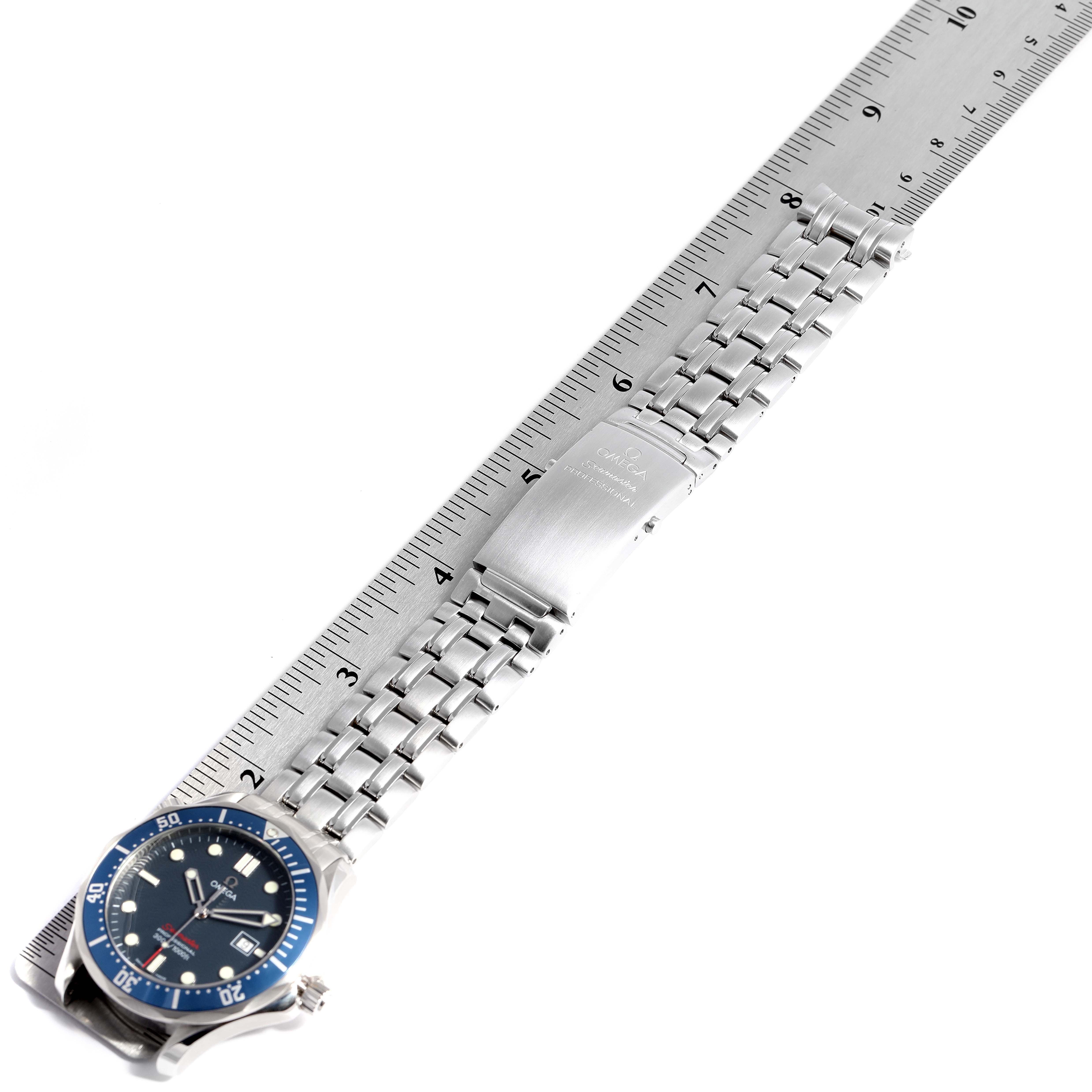 The Omega Seamaster 2221.80.00 Men
s Stainless Steel Blue Dial 2221.80.00 Men
s Stainless Steel Blue Dial watch is shown from a slightly diagonal angle, highlighting the face, bezel, and metal bracelet next to a ruler.
