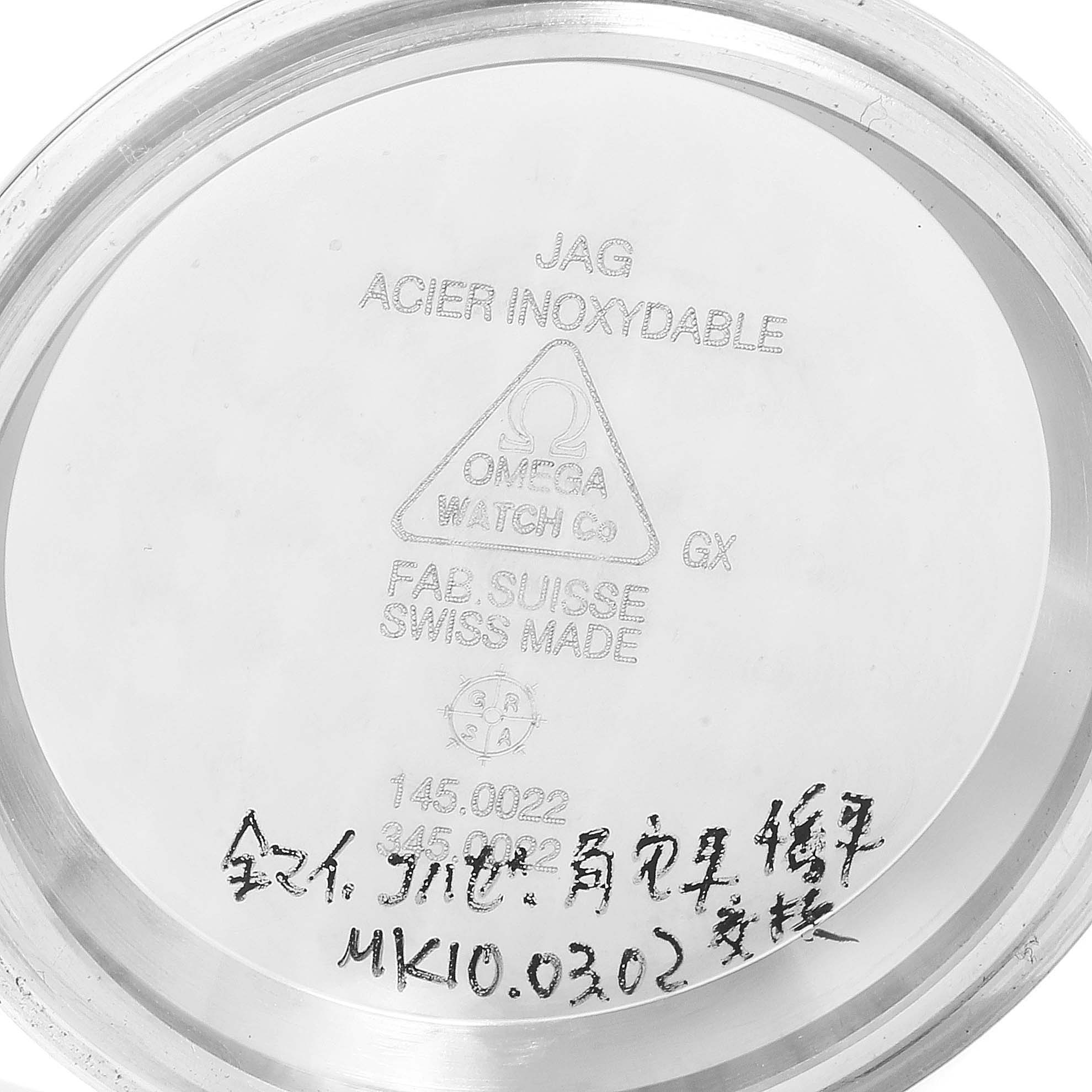 This image shows the inside case back of an Omega Speedmaster 3570.50.00 Men
s Stainless Steel Black Dial 3570.50.00 Men
s Stainless Steel Black Dial watch with various engravings and handwritten markings.