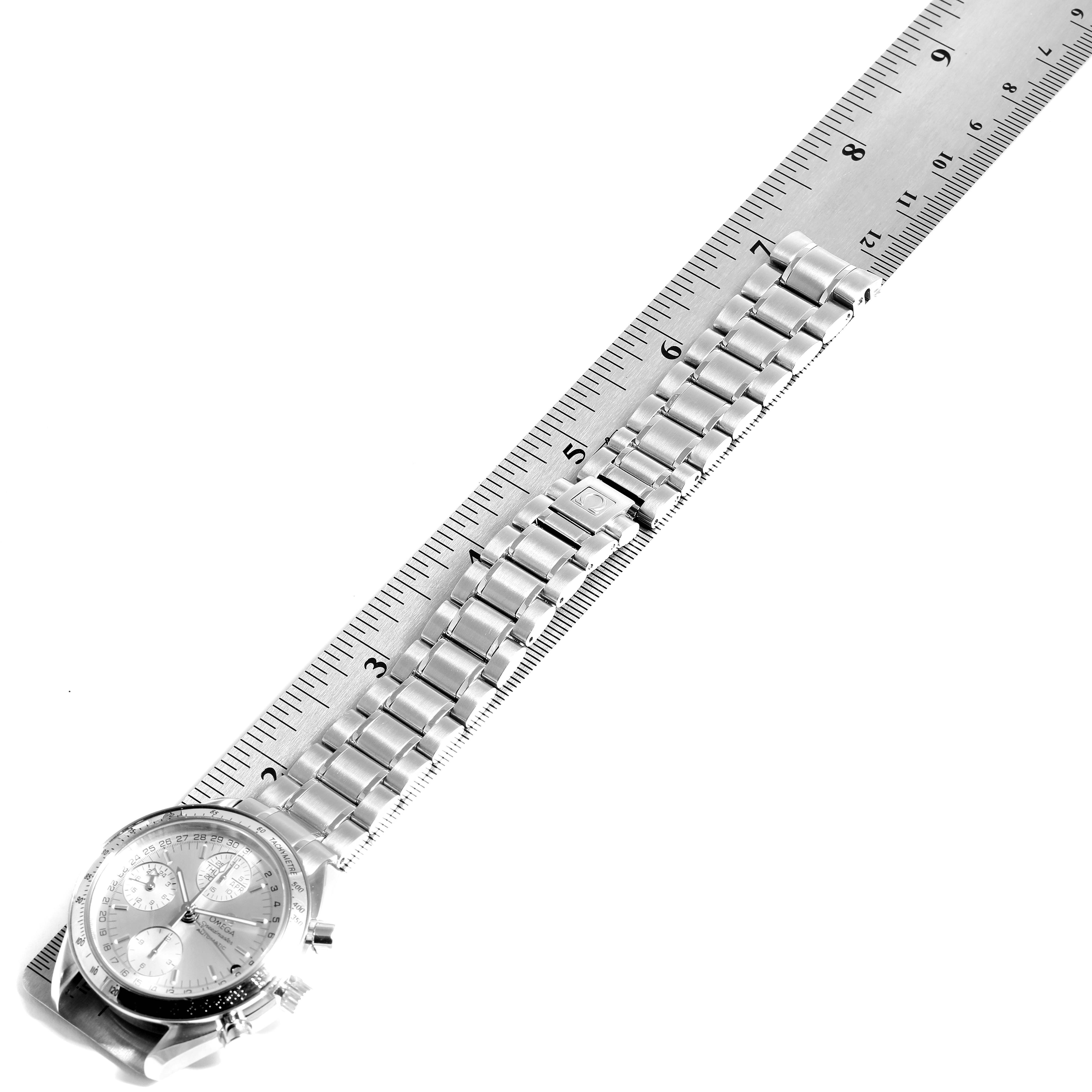 This image shows an Omega Speedmaster 3523.30.00 Men's Stainless Steel Silver Dial 3523.30.00 Men's Stainless Steel Silver Dial watch angled diagonally, with its dial and metal bracelet visible alongside a measuring ruler.