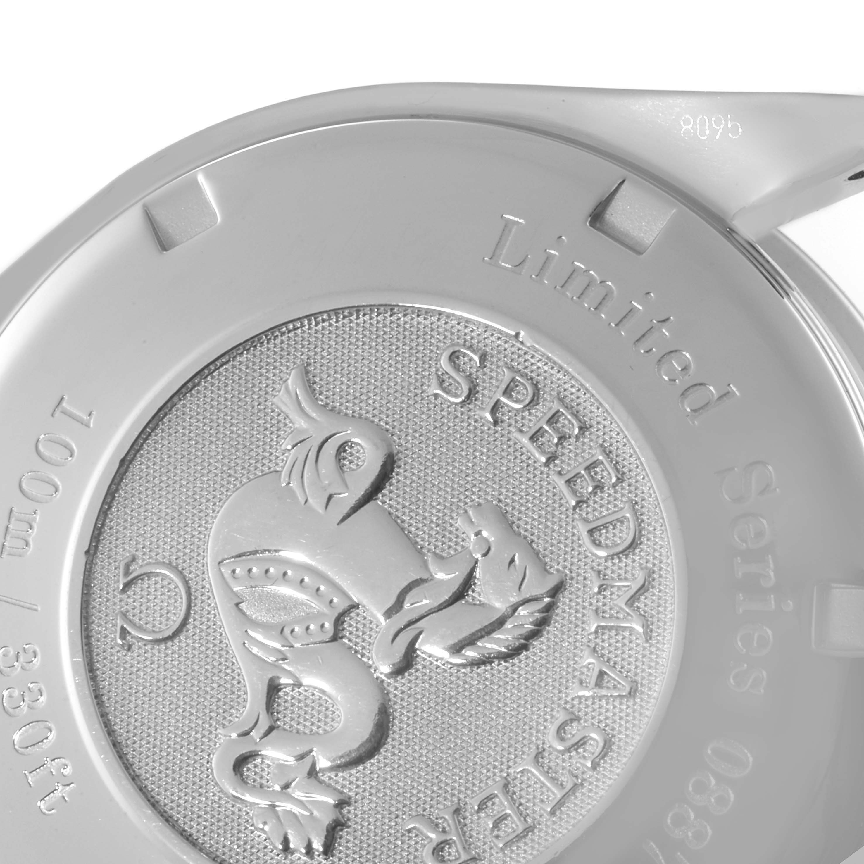 The image shows the back case of a Speedmaster model by Omega, featuring a detailed engrave and markings.