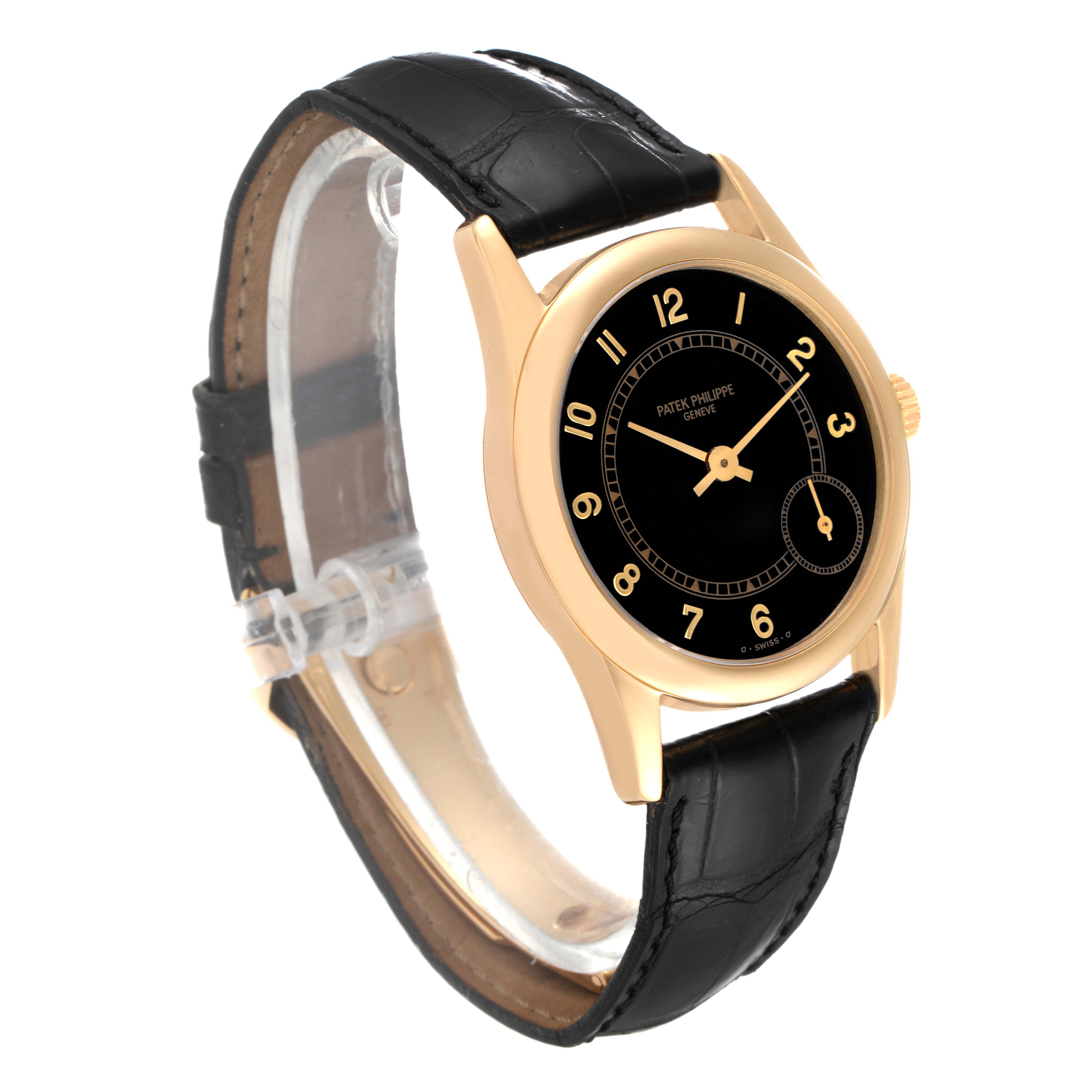 The Patek Philippe Calatrava 5000J Men's Yellow Gold Black Dial 5000J Men's Yellow Gold Black Dial watch is shown at a slight angle, highlighting its black dial, gold casing, and black leather strap.