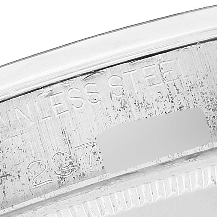 This image shows a close-up angle of the serial number engraving on the casing of a Vintage Collection Rolex watch.