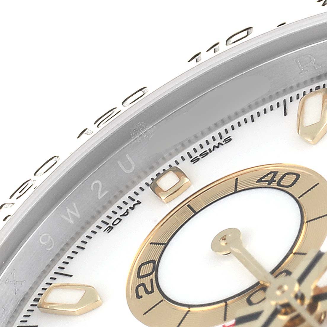The image shows a close-up of the dial and part of the bezel of the Rolex Daytona 116503 Men's Steel and Gold (two tone) White Dial 116503 Men's Steel and Gold (two tone) White Dial watch.