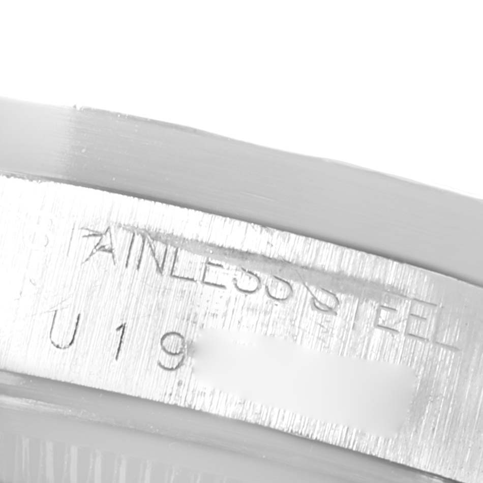 This image shows a close-up of the engraved side of the bezel of a Rolex Date 15210 Men's Stainless Steel Black Dial 15210 Men's Stainless Steel Black Dial model watch.