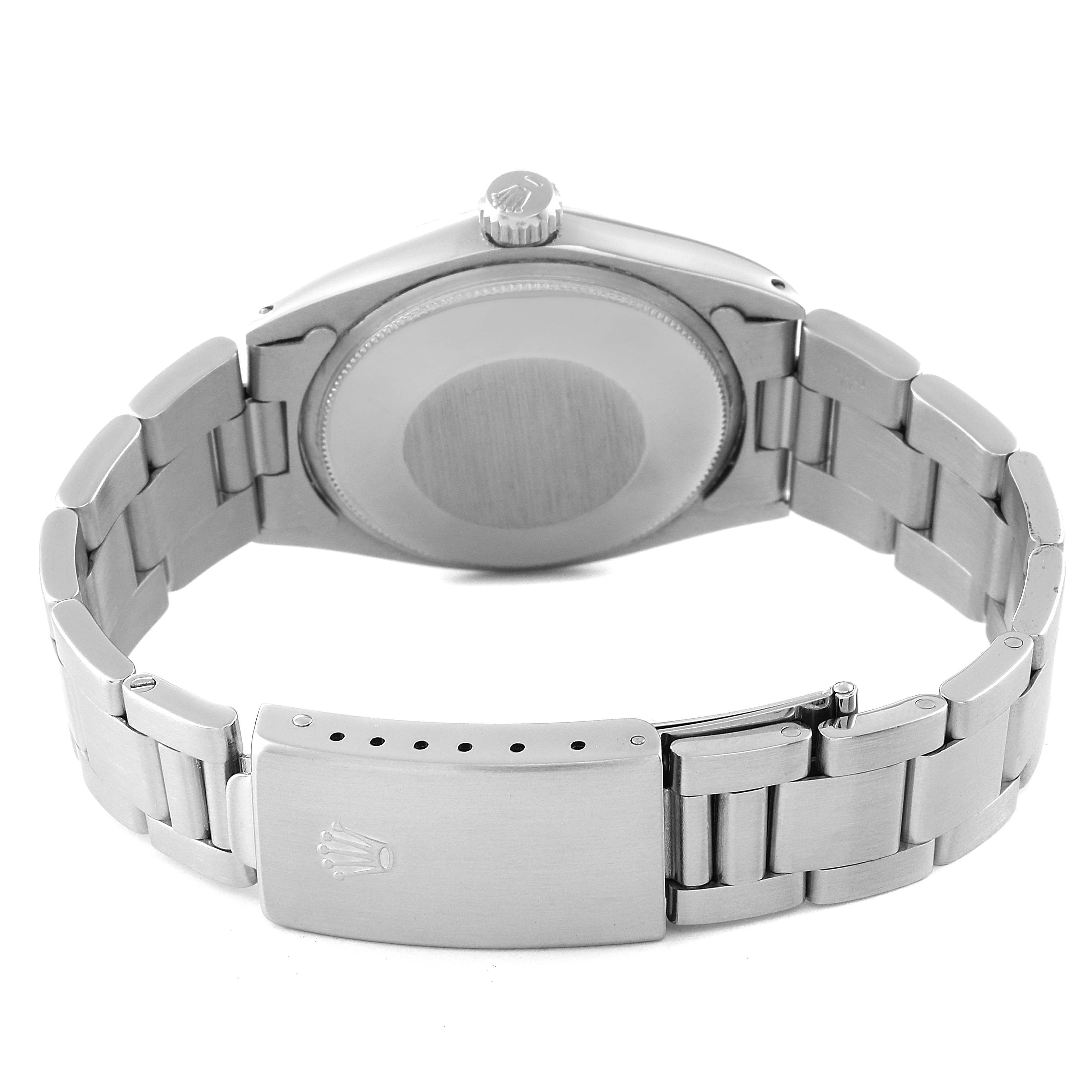 The image shows the back view of the vintage Rolex Collection model watch, highlighting the case back, crown, and bracelet with the clasp.