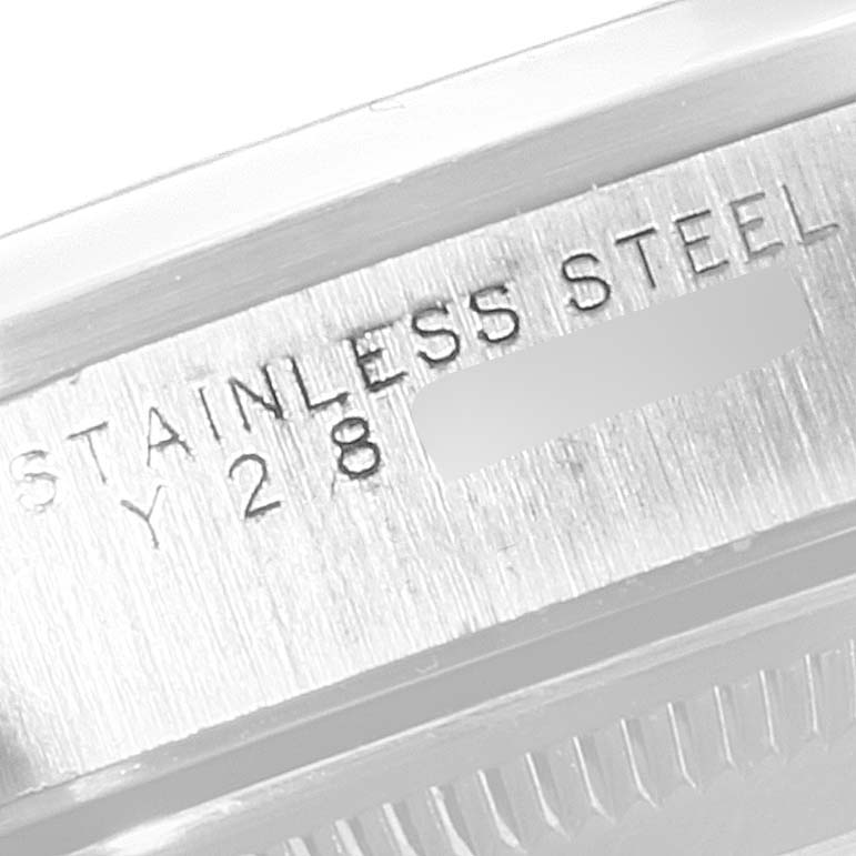 The image shows a close-up of the serial number engraving on the stainless steel case of a Rolex Date 15200 Men's Stainless Steel Silver Dial 15200 Men's Stainless Steel Silver Dial model watch.