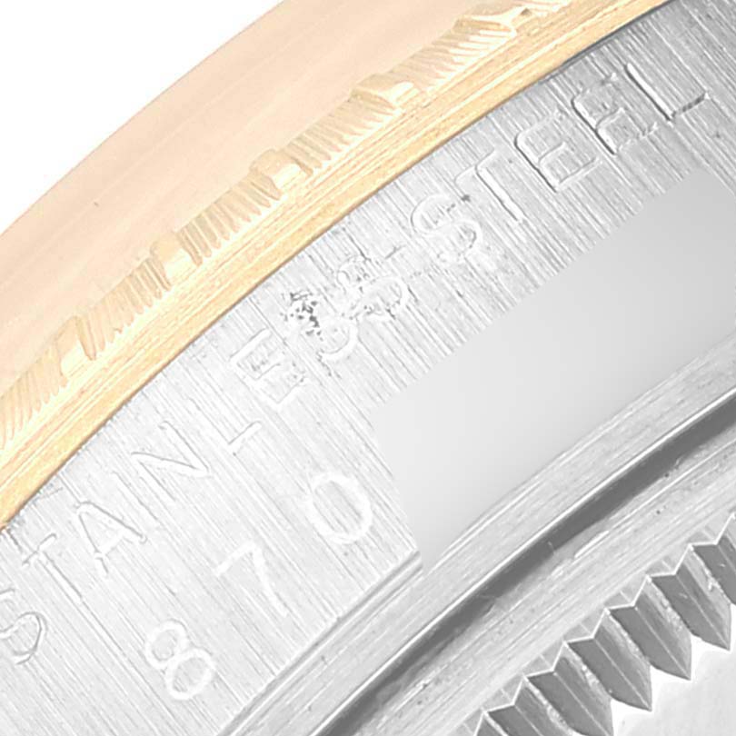 This close-up image shows the edge of the case back and bezel of a Rolex Date 15053 Men's Steel and Gold (two tone) Black Dial 15053 Men's Steel and Gold (two tone) Black Dial watch.