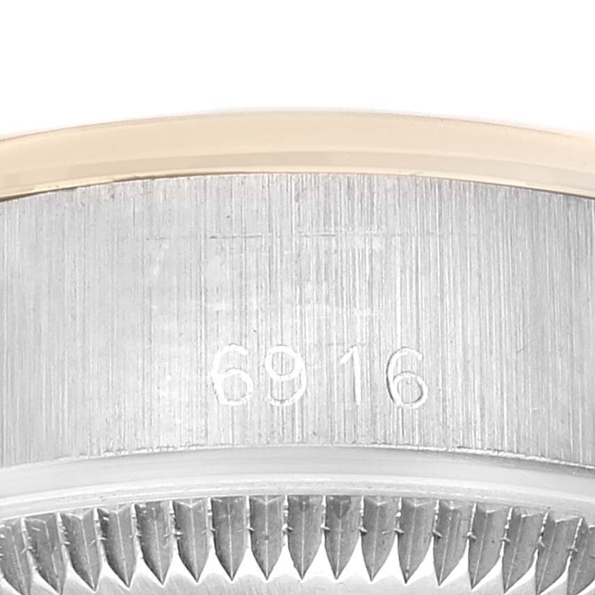 This close-up image of the Rolex Date 6916 Women's Steel and Gold (two tone) Champagne Dial 6916 Women's Steel and Gold (two tone) Champagne Dial model shows the case with the model number "6916" engraved on it.