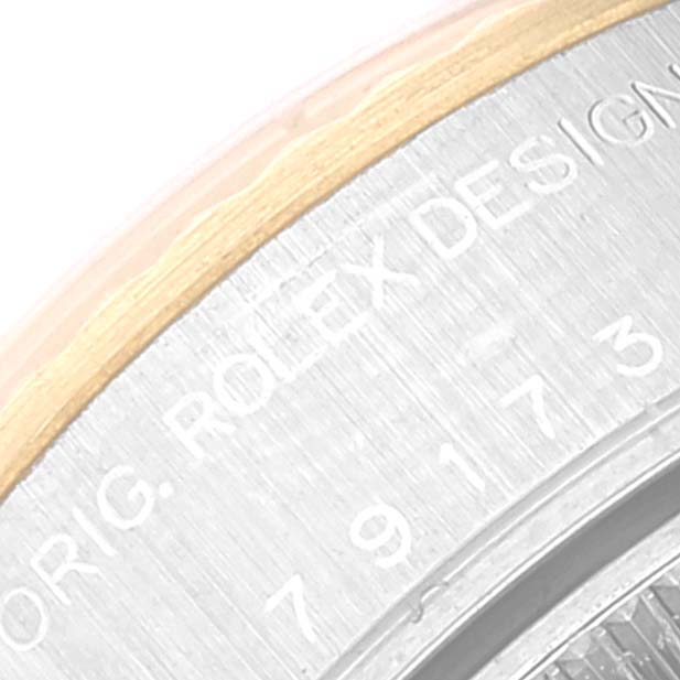 This image shows a close-up of the engraved text on the case back of a Rolex Datejust 79173 Women's Steel and Gold (two tone) White Dial 79173 Women's Steel and Gold (two tone) White Dial watch.