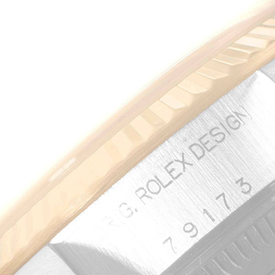 This image shows a close-up view of the side of a Rolex Datejust 79173 Women's Steel and Gold (two tone) White Dial 79173 Women's Steel and Gold (two tone) White Dial watch, highlighting the bezel and engraved text.