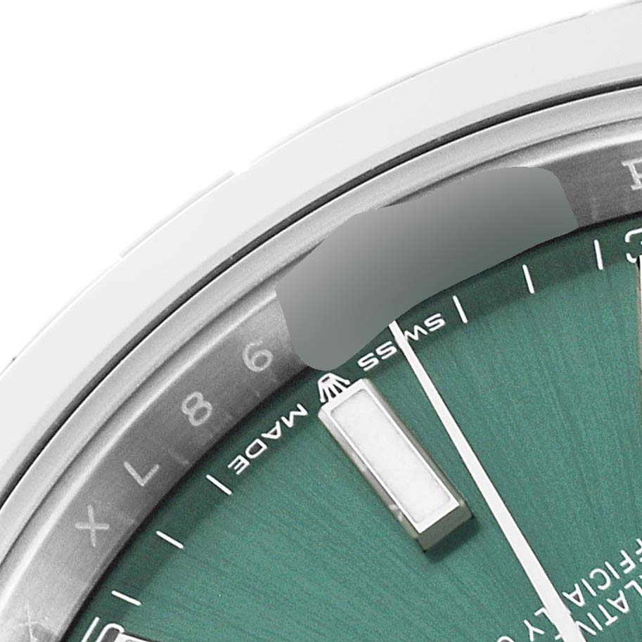 This close-up image shows the upper right portion of the dial and bezel of a Rolex Datejust 41 126300 Men
s Stainless Steel Green Dial 126300 Men
s Stainless Steel Green Dial watch.