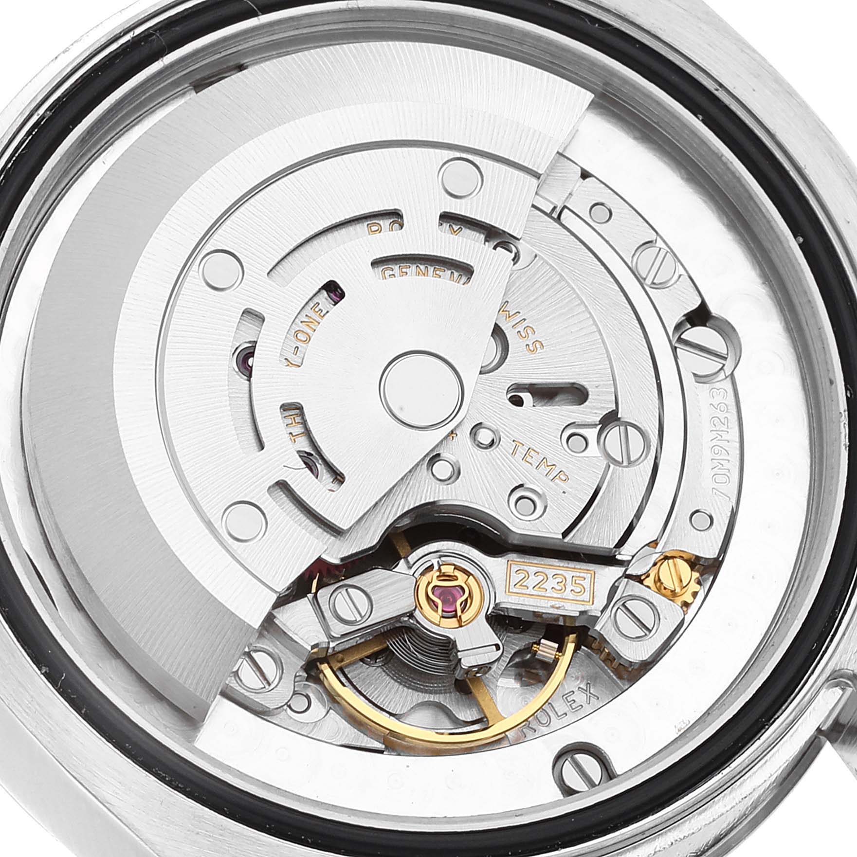 This image shows a detailed view of the mechanical movement inside a Mid-Size Rolex watch, angled from the back.