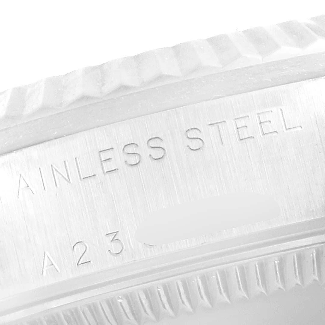 This is a close-up shot of the side of a Rolex Mid-Size 78274 Women's Stainless Steel Pink Dial 78274 Women's Stainless Steel Pink Dial watch showing part of the case with engraved "STAINLESS STEEL" text.