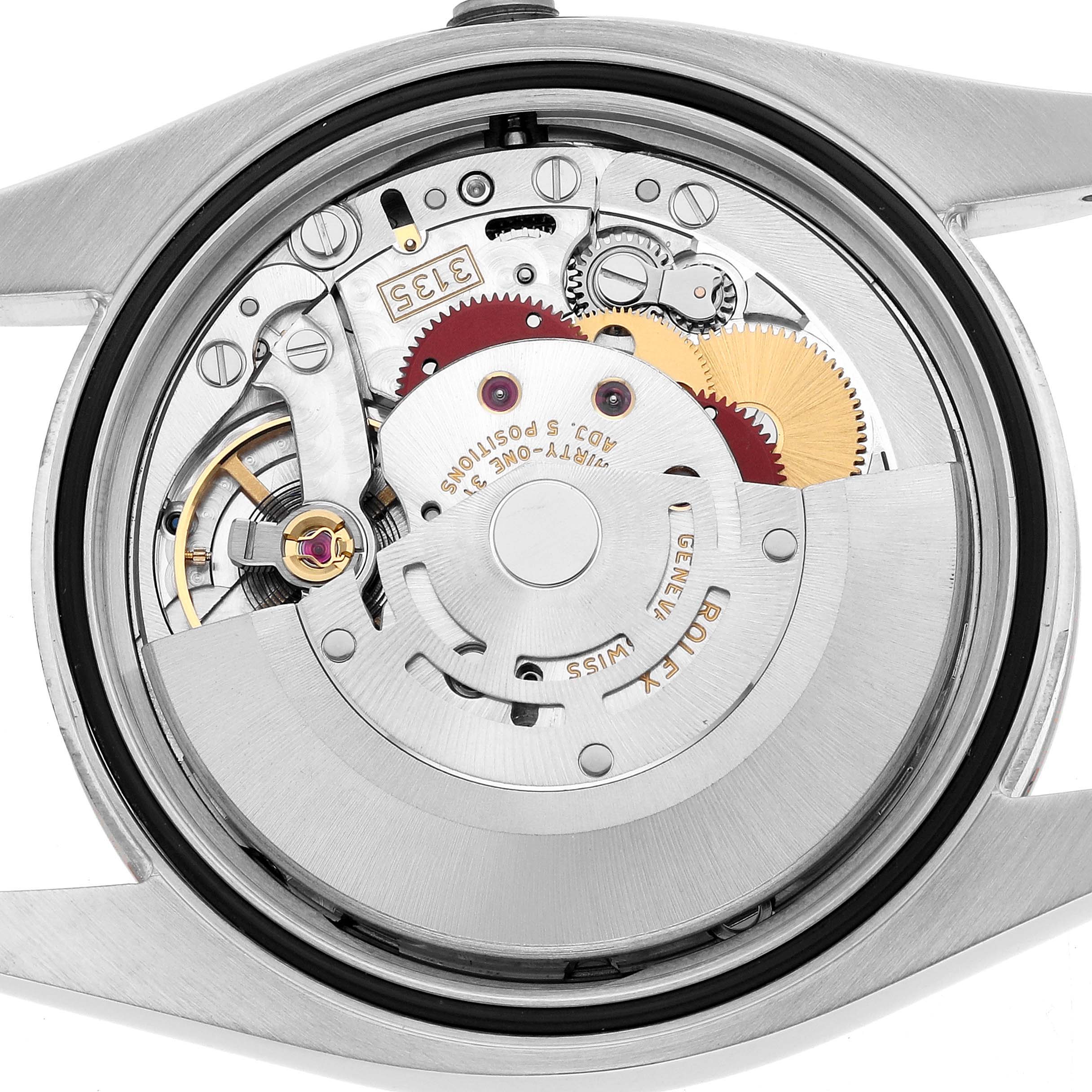 The image shows the Rolex Datejust 116201 Men's Steel and Gold (two tone) Silver Dial's movement from the back, highlighting gears and intricate mechanical components.