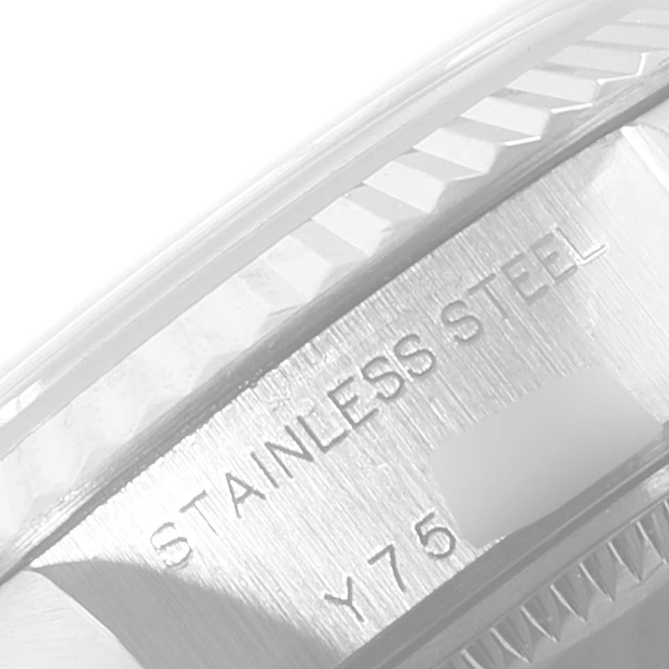 The image shows a close-up of the stainless steel case and the fluted bezel of a Rolex Datejust 79174 Women's Stainless Steel Black Dial 79174 Women's Stainless Steel Black Dial watch.