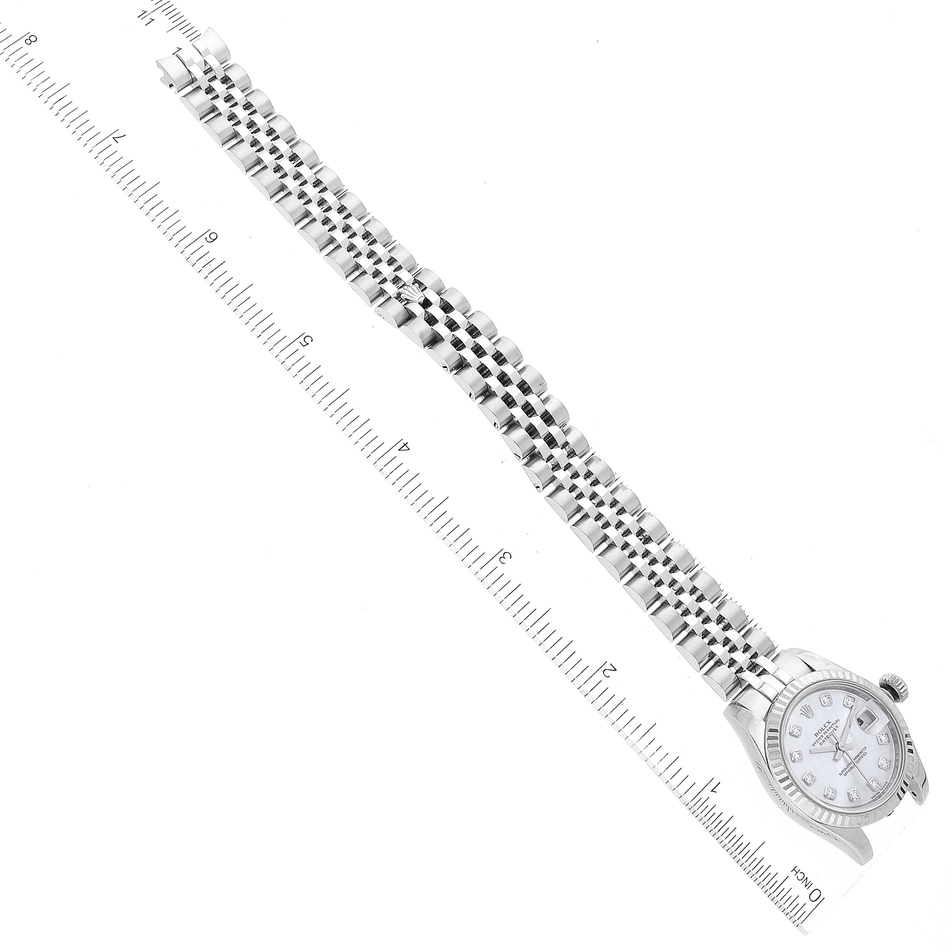 The image shows a Rolex Datejust 179174 Women's Stainless Steel Mother of Pearl Dial 179174 Women's Stainless Steel Mother of Pearl Dial watch laid flat, displaying the full bracelet and face, with a ruler for scale.
