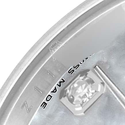 This close-up shows a partial dial of a Rolex Datejust 179174 Women's Stainless Steel Mother of Pearl Dial 179174 Women's Stainless Steel Mother of Pearl Dial watch, including a diamond hour marker and some text on the edge.