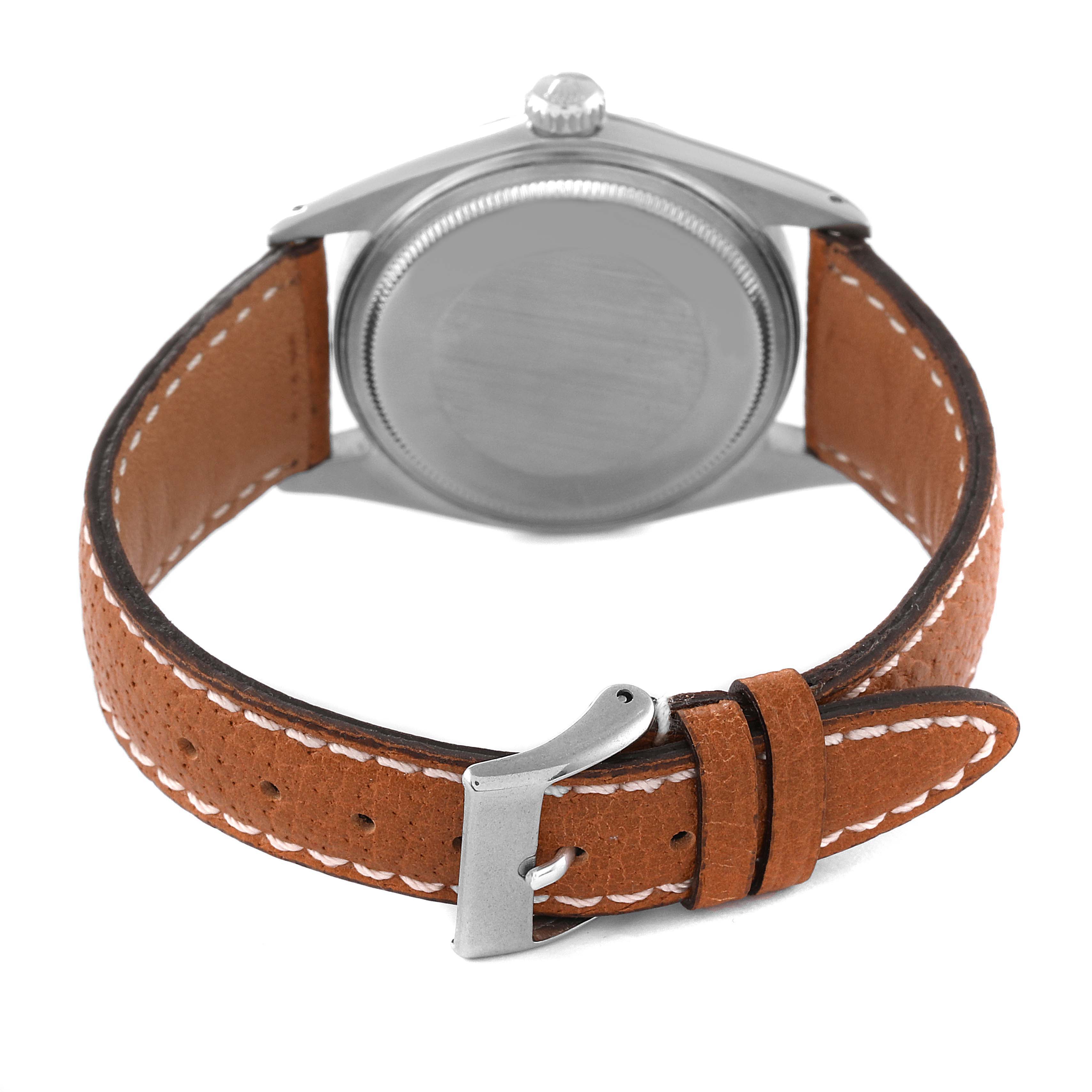 The image shows the back view of a Rolex Vintage Collection 1601 Men
s Stainless Steel Silver Dial 1601 Men
s Stainless Steel Silver Dial watch with a brown leather strap and silver buckle.