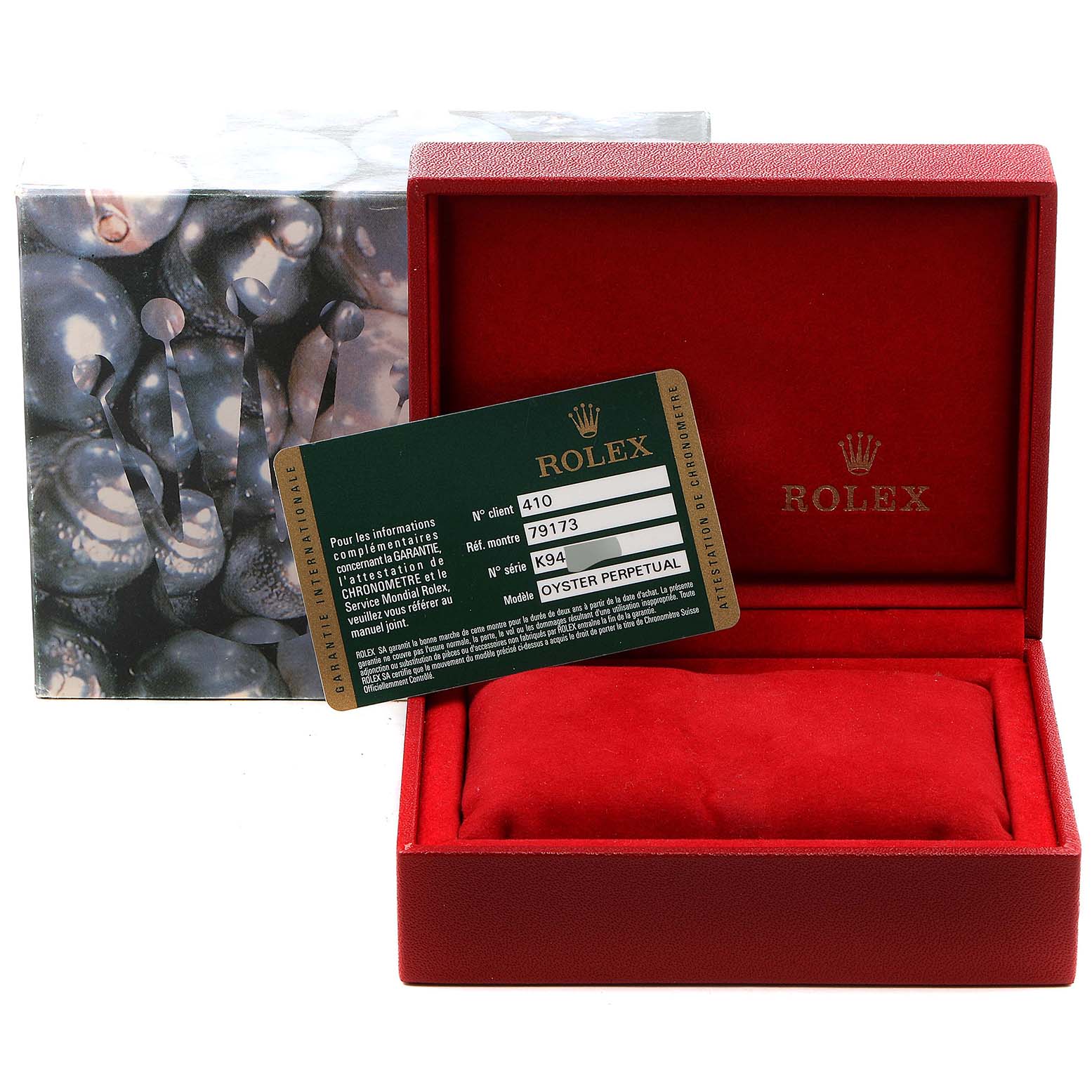 The image shows a Rolex Datejust 79173 Women's Steel and Gold (two tone) Blue Dial 79173 Women's Steel and Gold (two tone) Blue Dial box, a certification card, and a pillow for the watch.