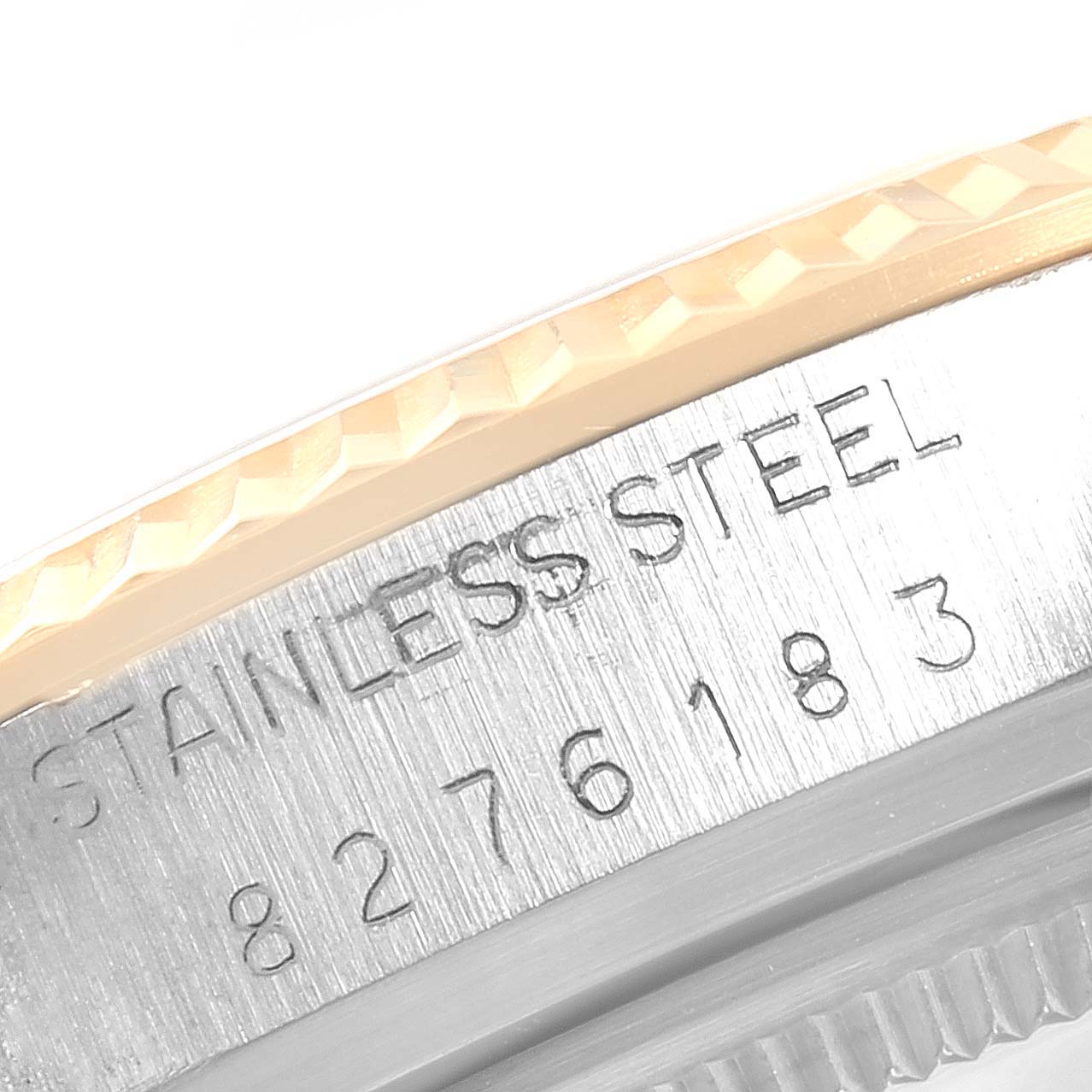 This image shows a close-up of the engraved stainless steel side and bezel of the Vintage Collection Rolex watch.