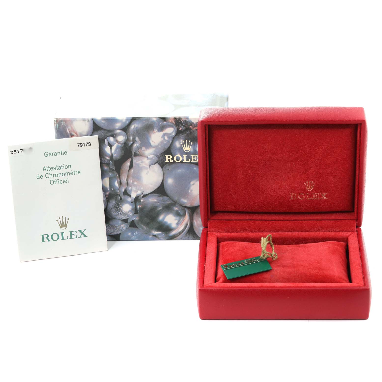 The image shows a red Rolex Datejust 79173 Women's Steel and Gold (two tone) Champagne Dial 79173 Women's Steel and Gold (two tone) Champagne Dial box, a warranty booklet, and a tag, all viewed from the front.