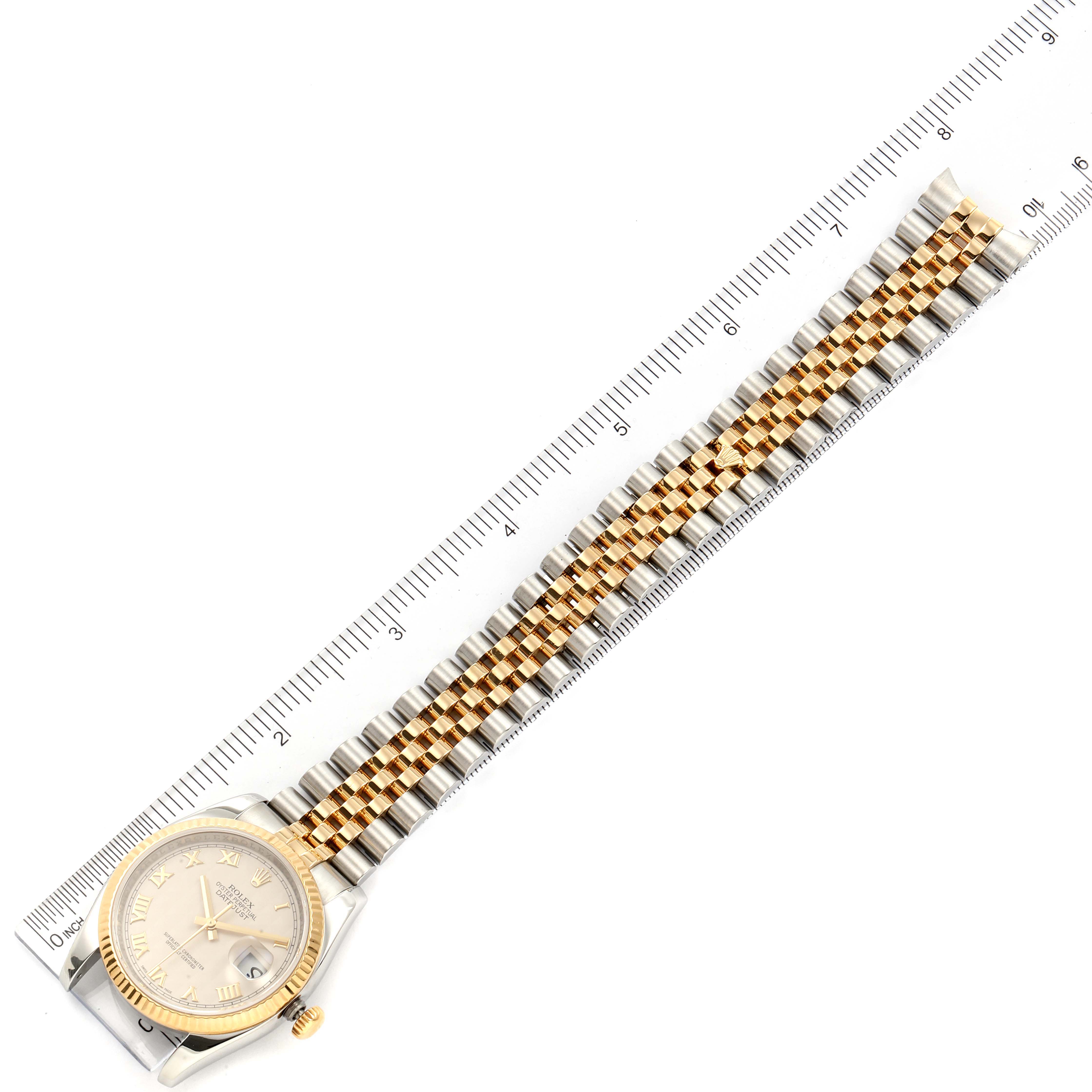 This image shows the entire Rolex Datejust 116233 Men
s Steel and Gold (two tone) Beige Dial 116233 Men
s Steel and Gold (two tone) Beige Dial watch laid flat, using a ruler for measurement.