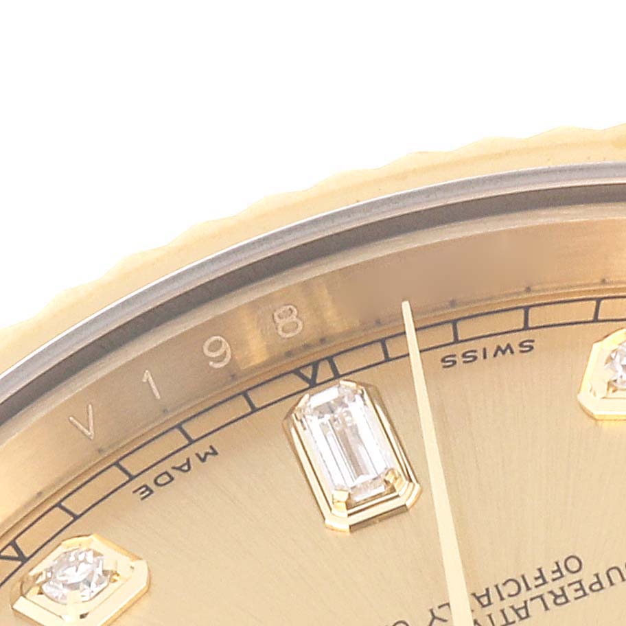 This is a close-up of a Rolex President 218238 Men's Yellow Gold Champagne Dial 218238 Men's Yellow Gold Champagne Dial model watch, showing the dial with diamond markers, partial bezel, and minute hand.