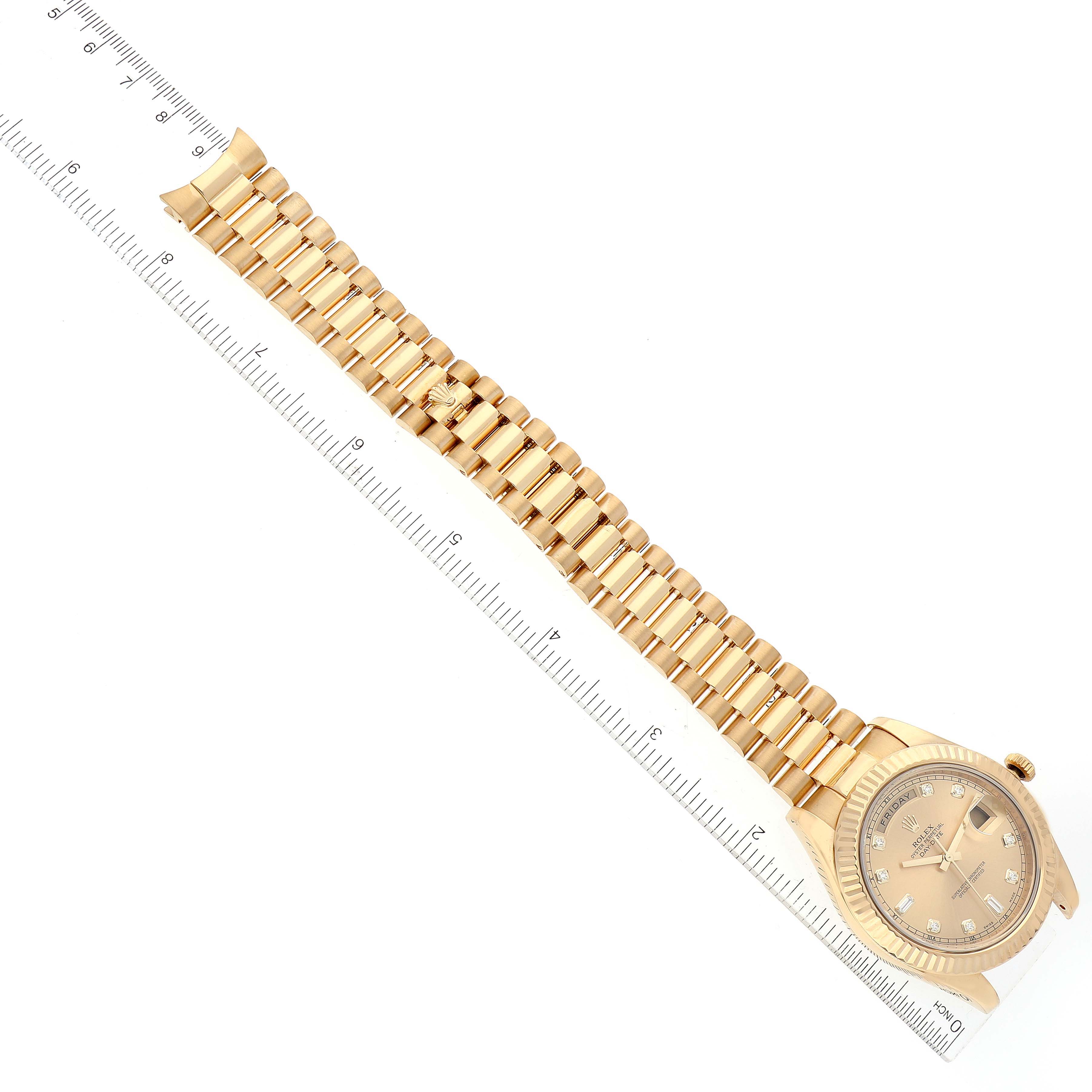 The image shows a Rolex President 218238 Men's Yellow Gold Champagne Dial 218238 Men's Yellow Gold Champagne Dial model watch laid flat with a ruler next to it, highlighting its gold bracelet and face.