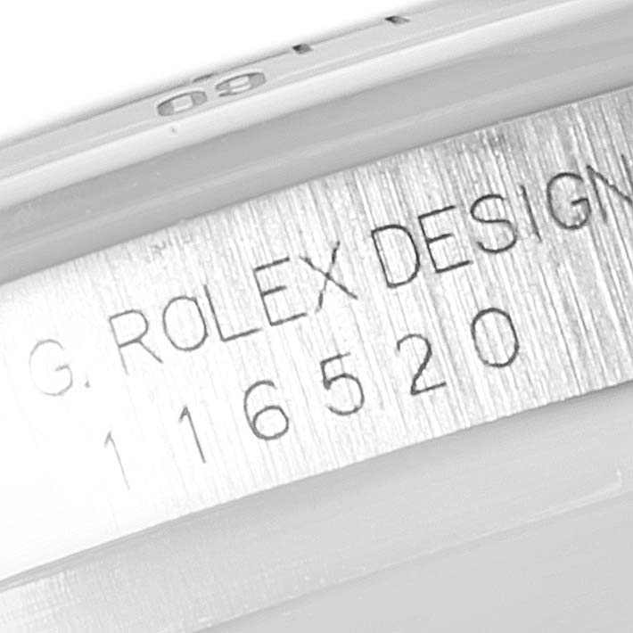 This image shows the engraved serial number and "Rolex Design" text on the inner rim of a Rolex Daytona 116520 Men's Stainless Steel Black Dial 116520 Men's Stainless Steel Black Dial watch case.