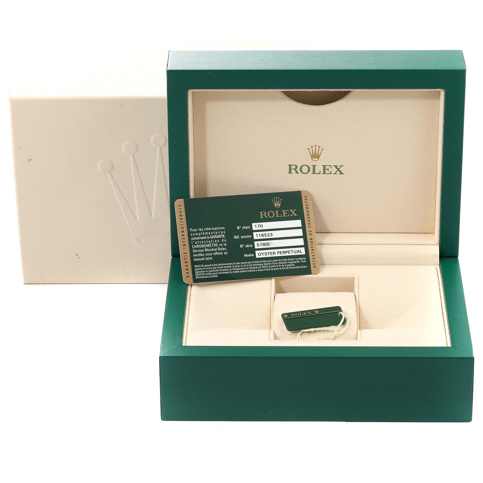 This is the green and cream packaging of a Rolex Daytona 116523 Men
s Steel and Gold (two tone) Black Dial 116523 Men
s Steel and Gold (two tone) Black Dial watch, showing the box, warranty card, and card holder.