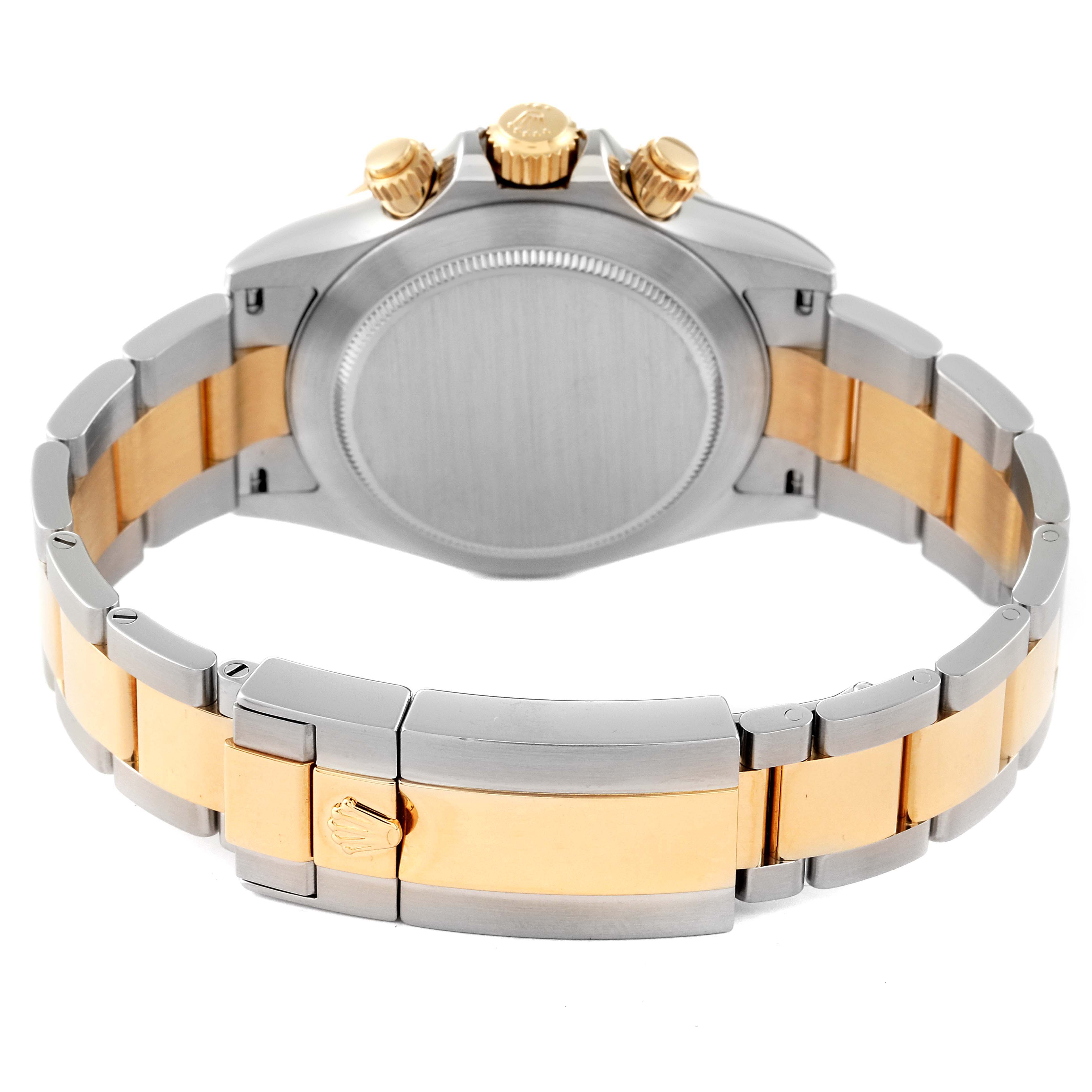 The image shows the back and clasp of a Rolex Daytona 116523 Men
s Steel and Gold (two tone) Black Dial 116523 Men
s Steel and Gold (two tone) Black Dial watch, highlighting the two-tone metal bracelet.