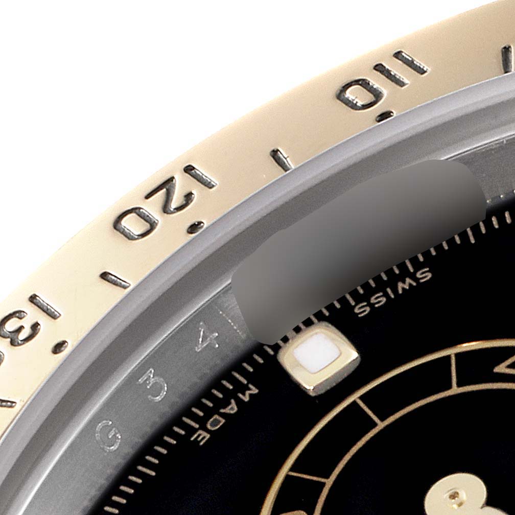 This is a close-up view of the bezel and a section of the dial of the Rolex Daytona 116523 Men
s Steel and Gold (two tone) Black Dial 116523 Men
s Steel and Gold (two tone) Black Dial watch.