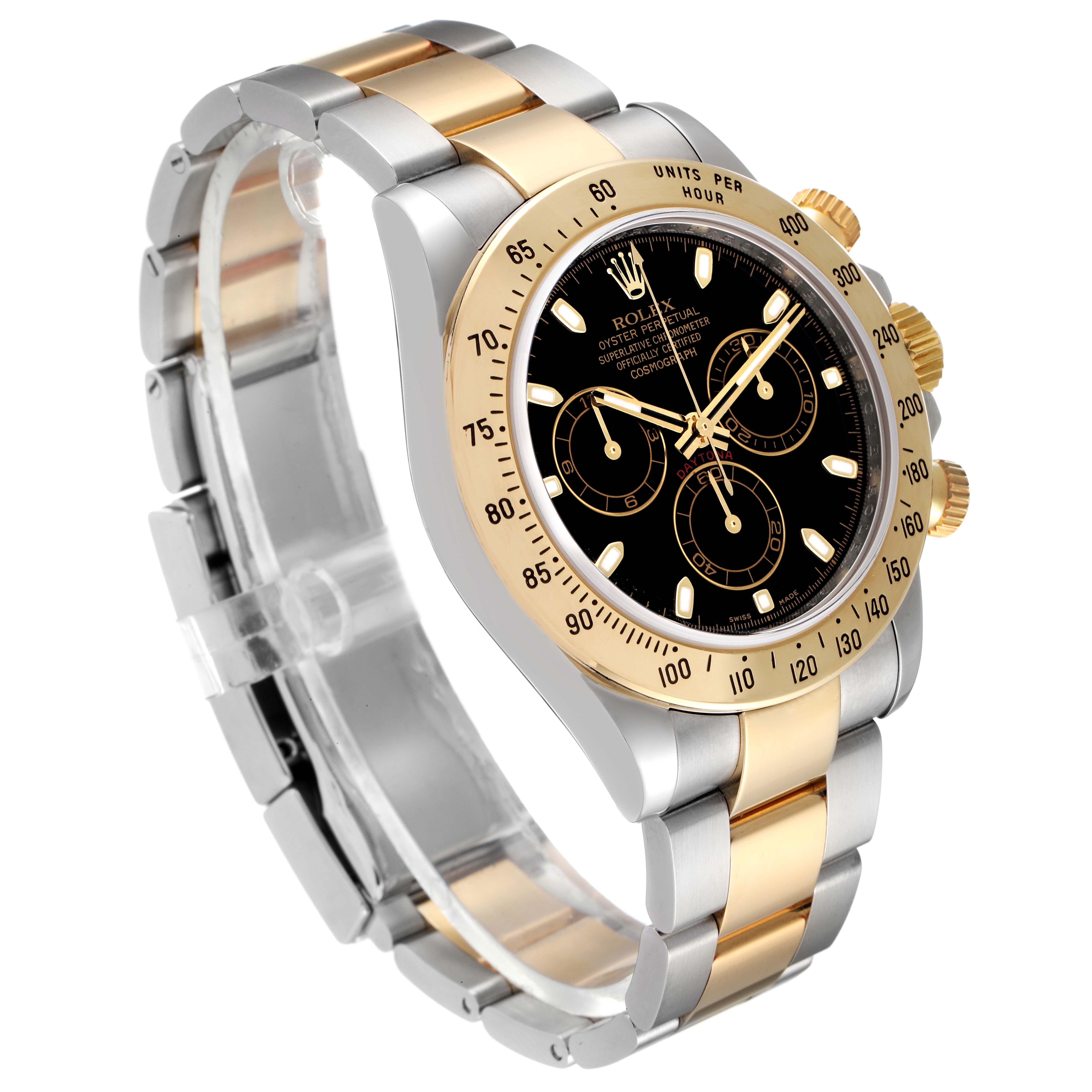 The image shows a Rolex Daytona 116523 Men
s Steel and Gold (two tone) Black Dial 116523 Men
s Steel and Gold (two tone) Black Dial watch at an oblique angle, highlighting its dial, bezel, and two-tone metal bracelet.