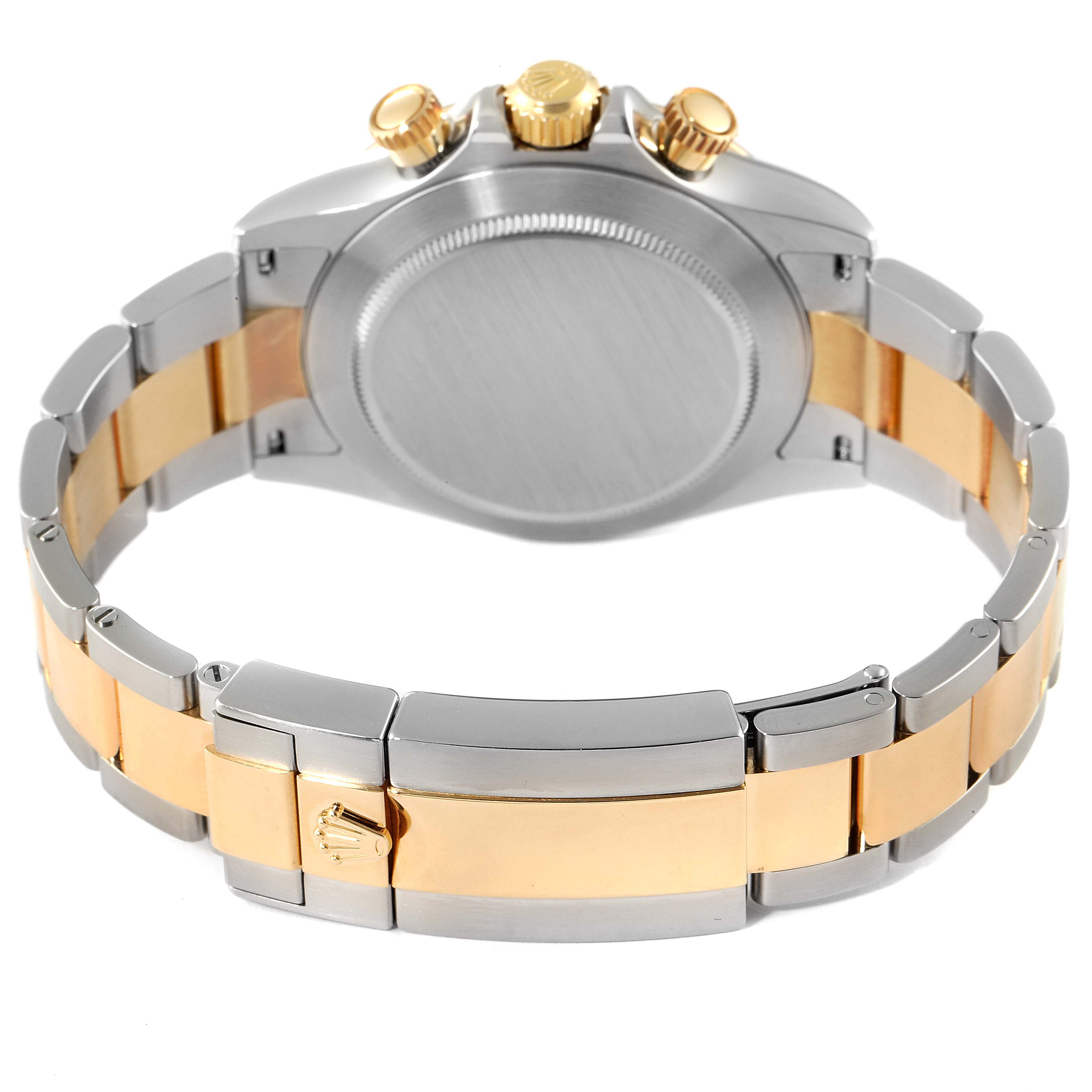 The image shows the back and band of a Rolex Daytona 116523 Men
s Steel and Gold (two tone) Black Dial 116523 Men
s Steel and Gold (two tone) Black Dial watch, featuring a two-tone metal bracelet and clasp.