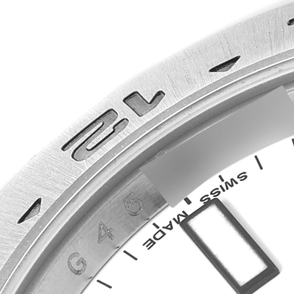 This image shows a close-up of the bezel, part of the dial, and hour markers of a Rolex Explorer 216570 Men
s Stainless Steel White Dial 216570 Men
s Stainless Steel White Dial watch.