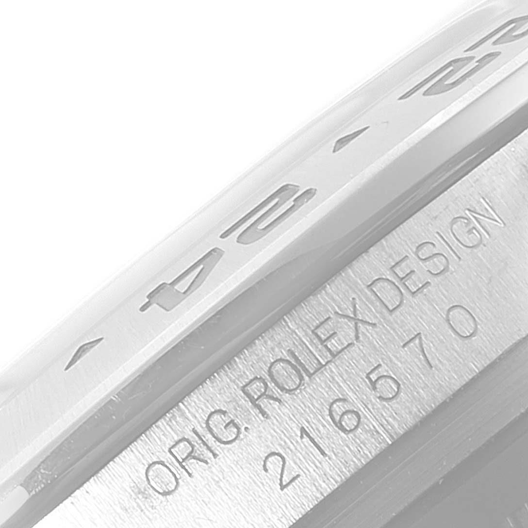 This image shows a close-up view of the bezel and case engraving on a Rolex Explorer 216570 Men
s Stainless Steel White Dial 216570 Men
s Stainless Steel White Dial watch.
