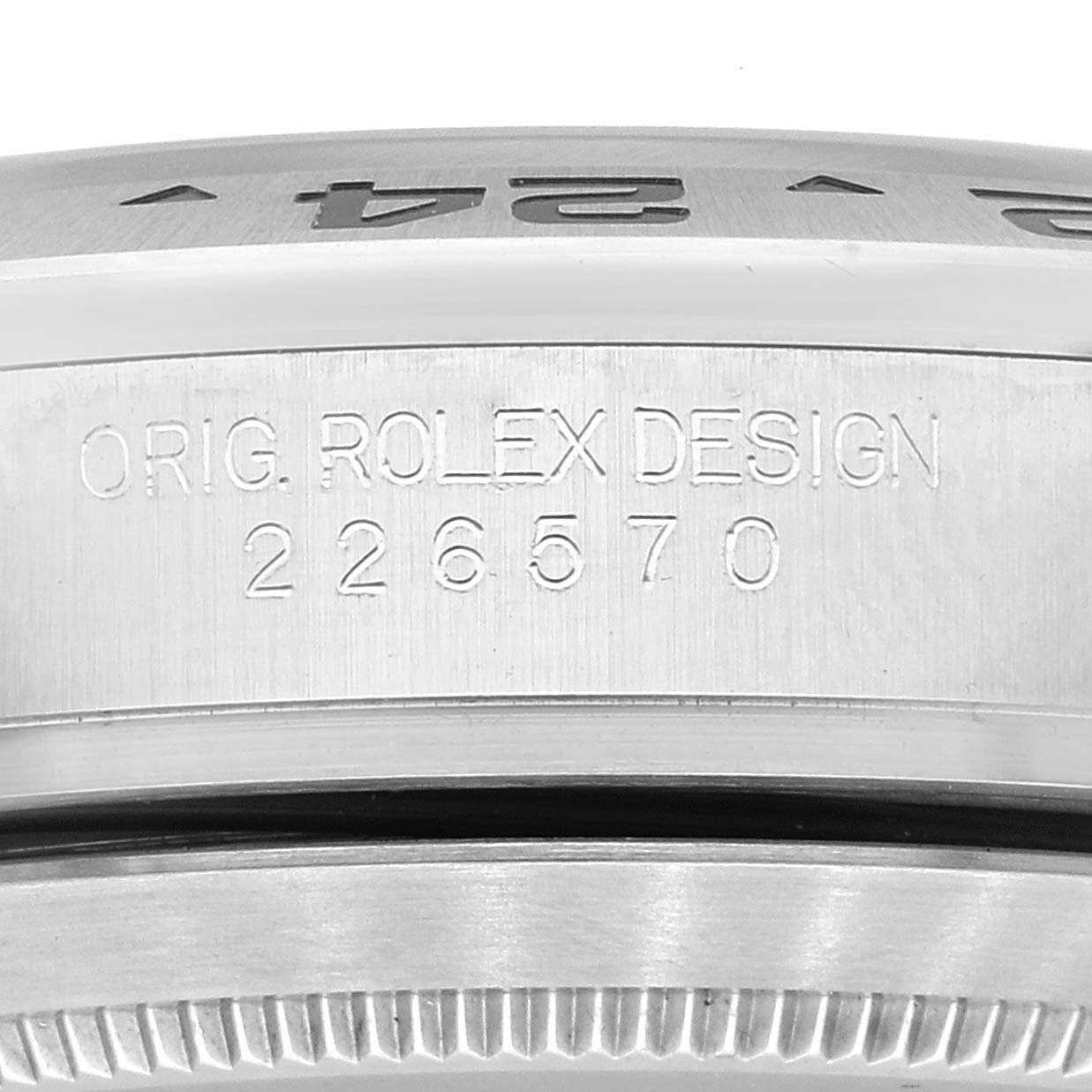 This image shows a close-up of the side of a Rolex Explorer 226570 Men
s Stainless Steel White Dial 226570 Men
s Stainless Steel White Dial watch with the model number 226570 and "ORIG. ROLEX DESIGN" engraved.