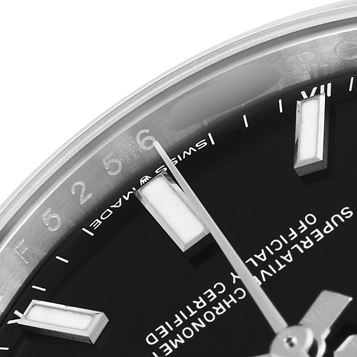 This close-up angle of the Rolex Oyster Perpetual 124200 Men's Stainless Steel Black Dial 124200 Men's Stainless Steel Black Dial watch shows part of the dial, including the hour markers, and the hour and minute hands.