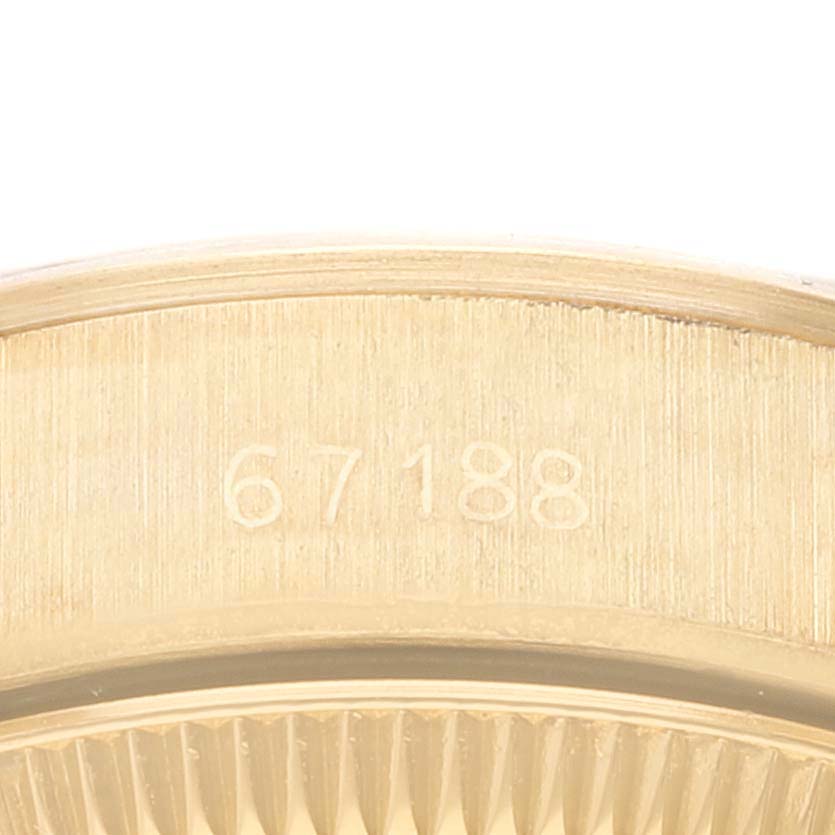The image shows a close-up of the case and serial number of a Rolex President 67188 Women
s Yellow Gold Champagne Dial 67188 Women
s Yellow Gold Champagne Dial model watch.