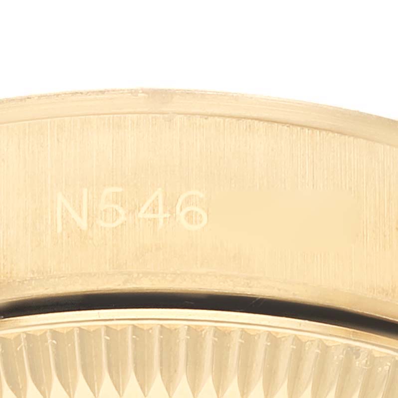 This close-up image shows the rim and outer casing of a Rolex President 67188 Women
s Yellow Gold Champagne Dial 67188 Women
s Yellow Gold Champagne Dial model watch, with part numbers engraved.