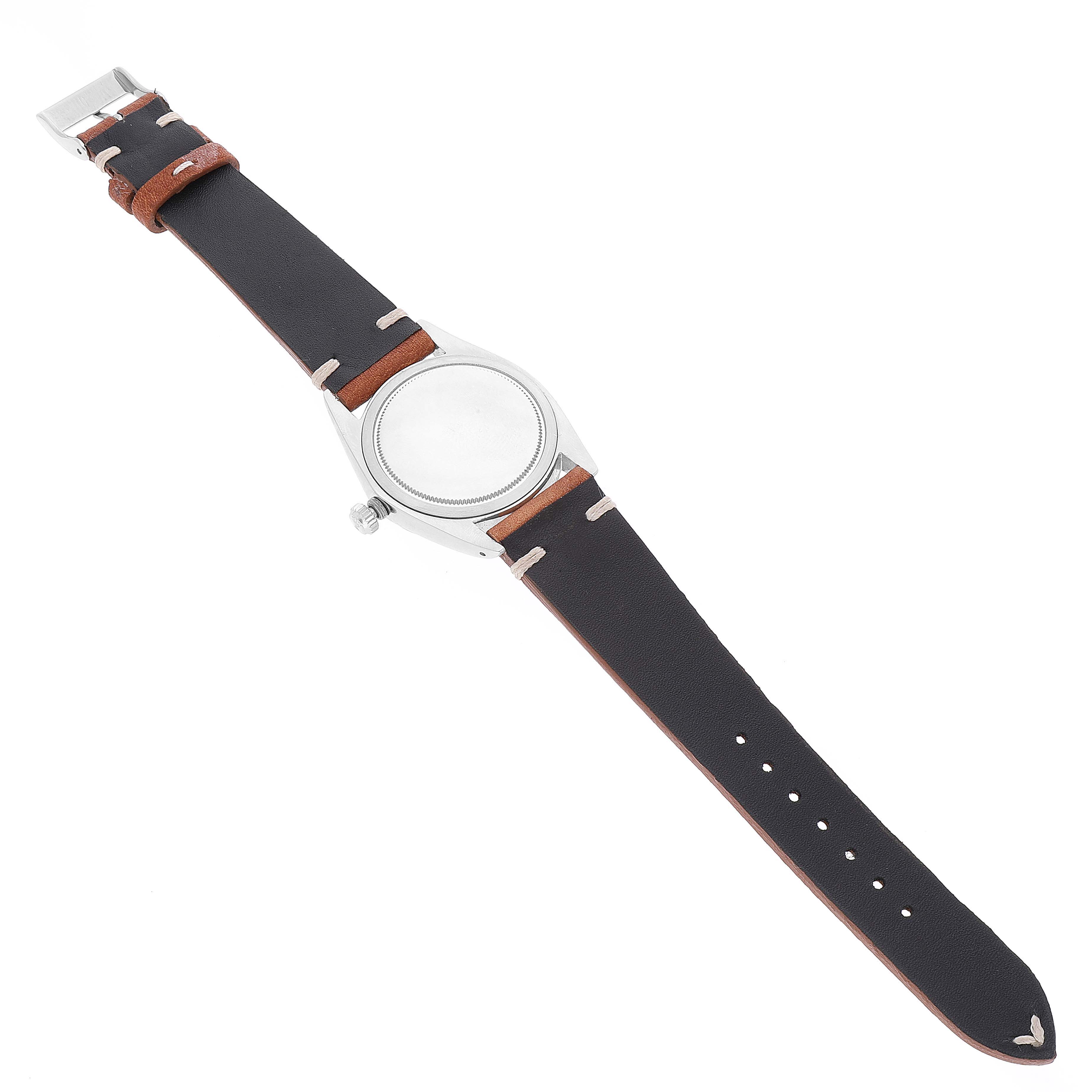 The image shows a top-down view of a Rolex Vintage Collection 6694 Men's Stainless Steel Blue Dial 6694 Men's Stainless Steel Blue Dial watch with a black and brown leather strap.