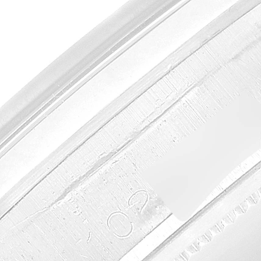 The close-up angle shows a portion of the Rolex Vintage Collection 6694 Men's Stainless Steel Blue Dial 6694 Men's Stainless Steel Blue Dial watch's outer rim, highlighting part of its engraving.