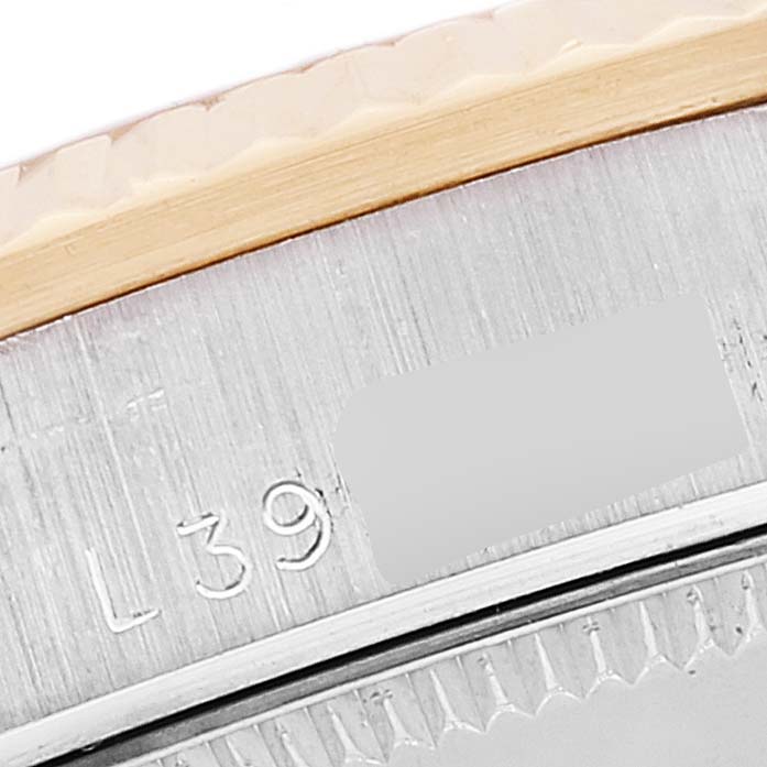 The image shows a close-up of the side and edge of the bezel of a Rolex President 68279 Women's White Gold Brown Dial 68279 Women's White Gold Brown Dial model watch, revealing partial serial engravings.