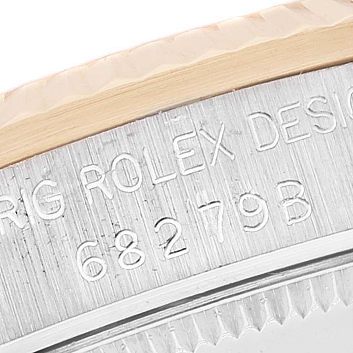 This close-up image shows the engraved serial number and edge of the bezel of a Rolex President 68279 Women's White Gold Brown Dial 68279 Women's White Gold Brown Dial watch.
